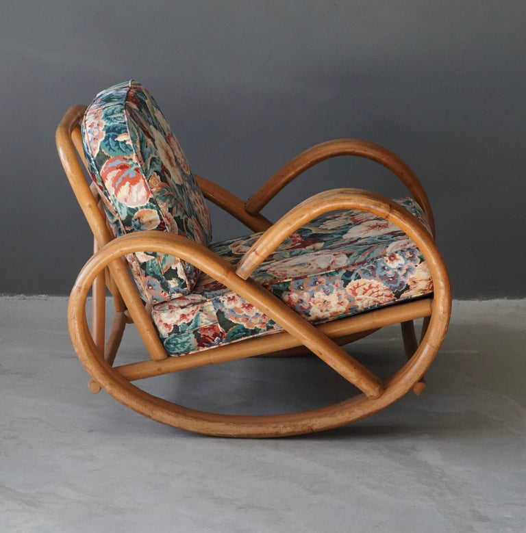 An organic rocking lounge chair, in moulded bamboo. Designed and produced in the United States, 1950s. Cushions in a vintage fabric with floral motifs.

Other designers of the period include Paul Frankl, Paul Laszlo, Vladimir Kagan, Charles and