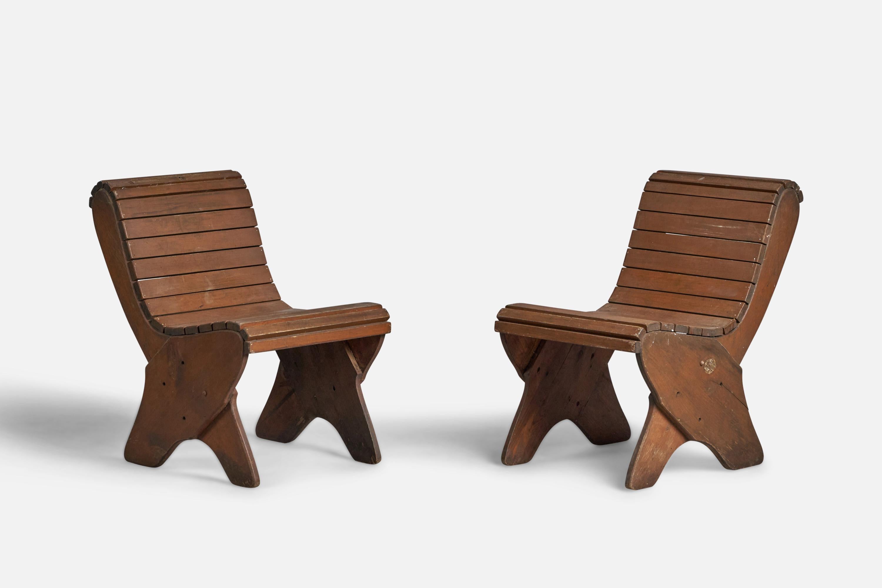A pair of stained wood side chairs designed and produced in the US, c. 1940s.

16” seat height
