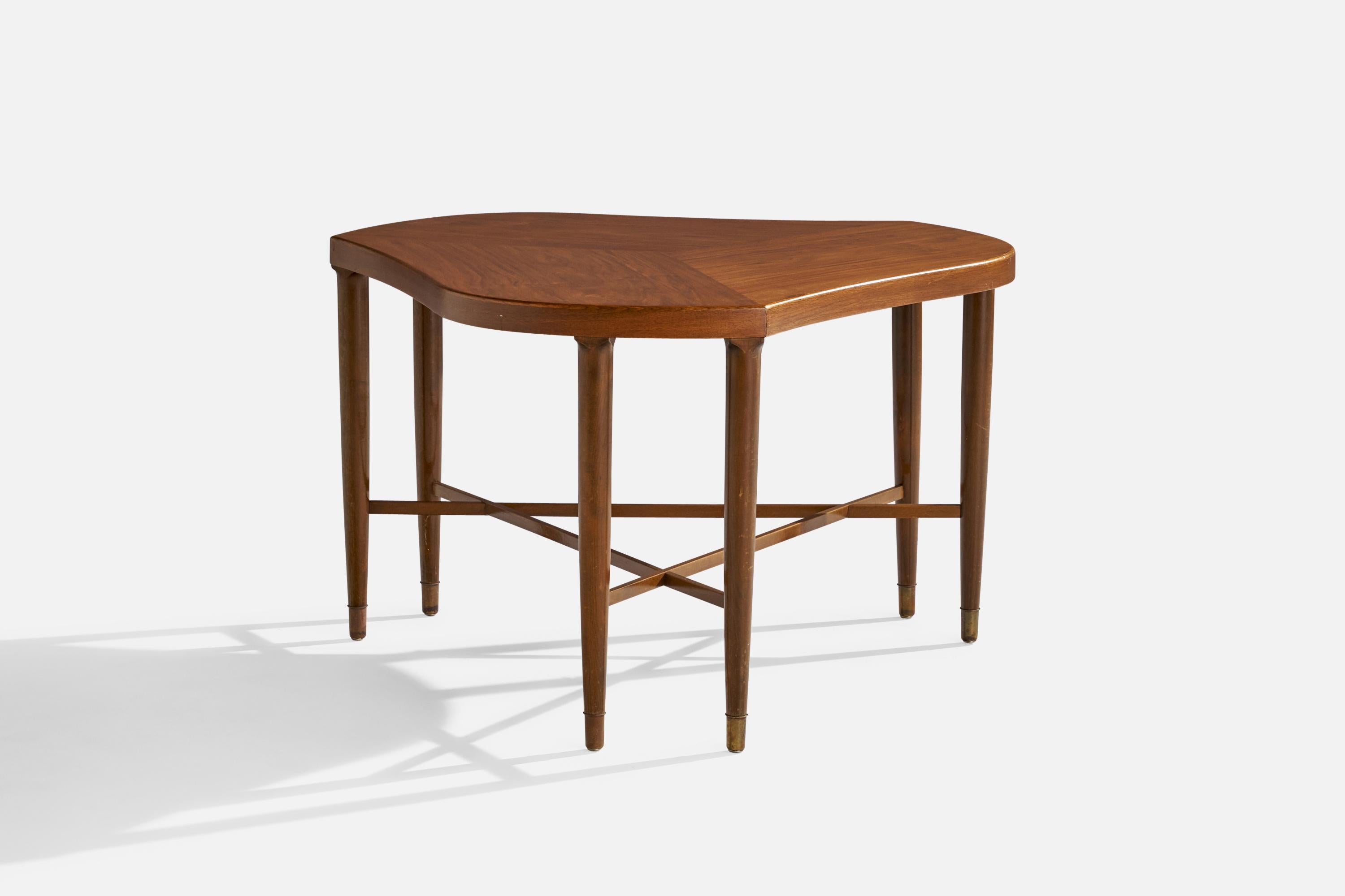 A freeform walnut and brass side table designed and produced in the US, 1954.