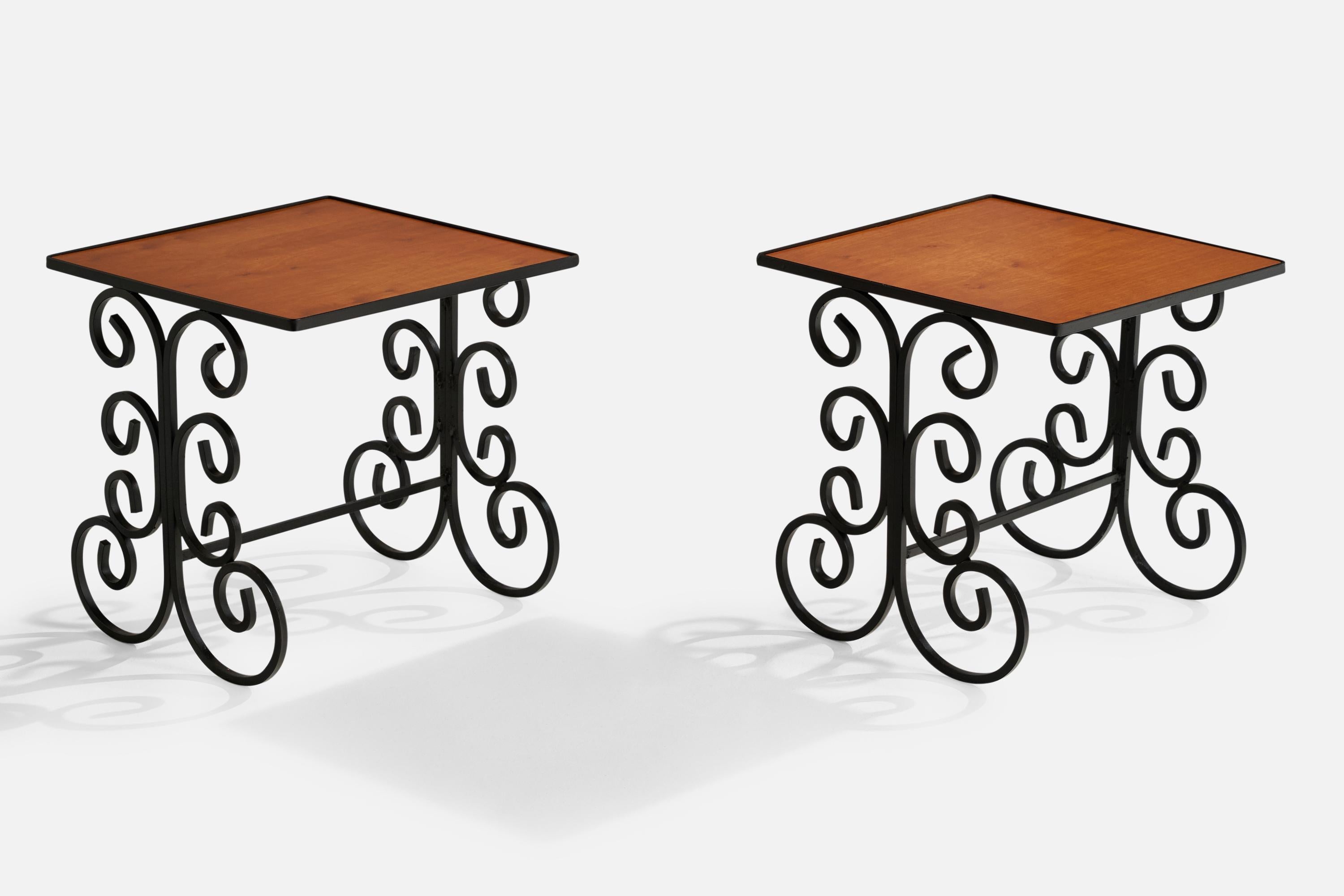 A pair of black-painted iron and maple side tables designed and produced in the US, c. 1940s.