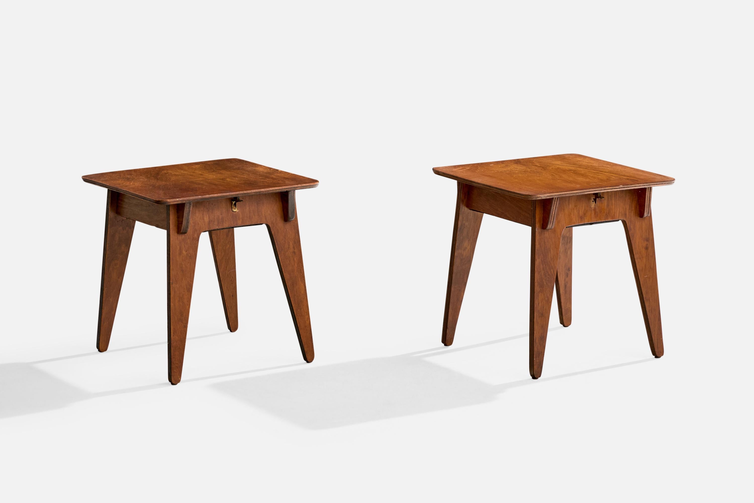 A pair of dark-stained plywood and brass side tables with storage likely designed and produced in the US, c. 1930s.

The tabletops present with light discoloration throughout.

Overall Dimensions (inches): 16.75