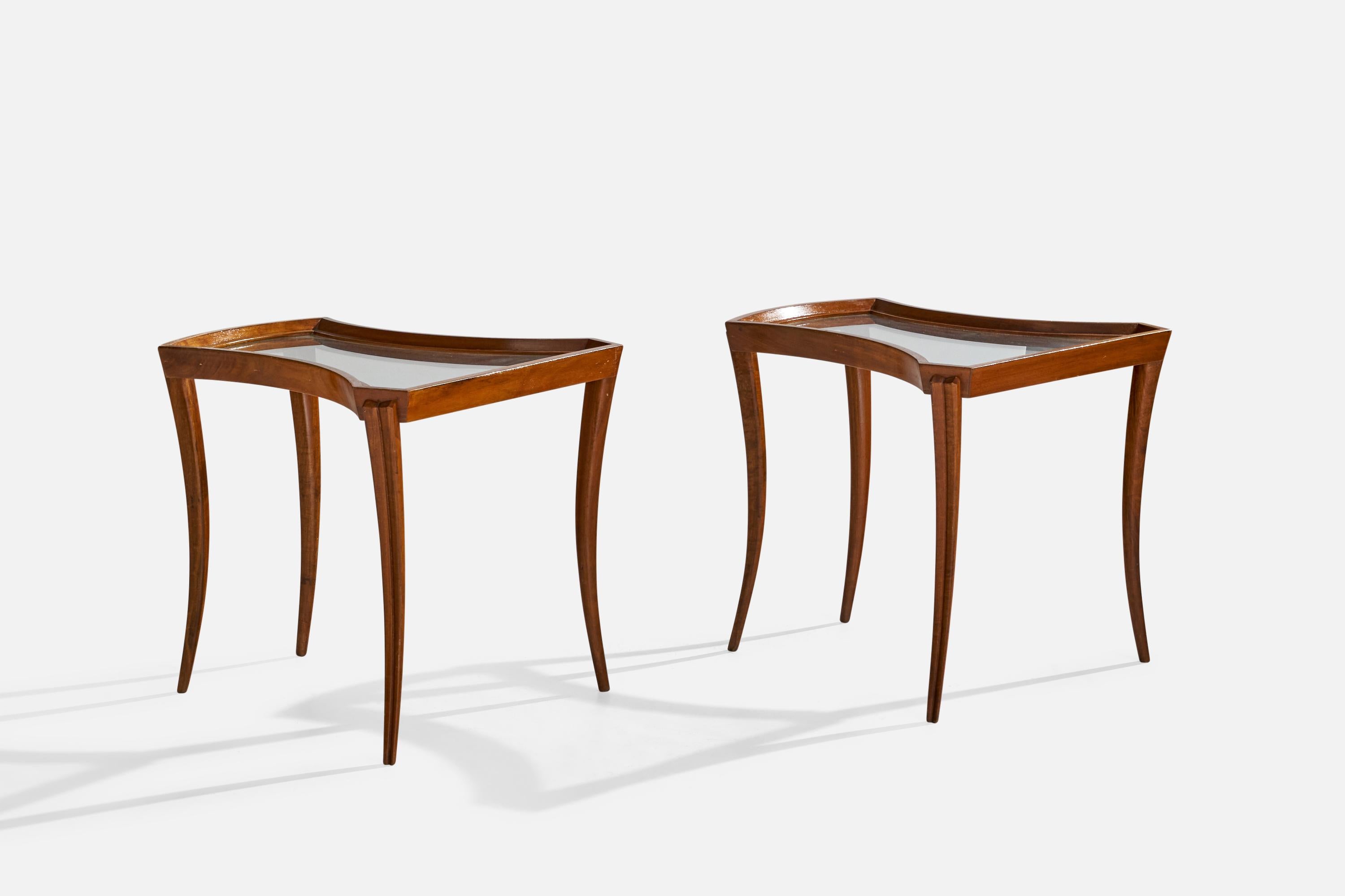 A pair of walnut and glass side tables designed and produced in the US, c. 1940s.