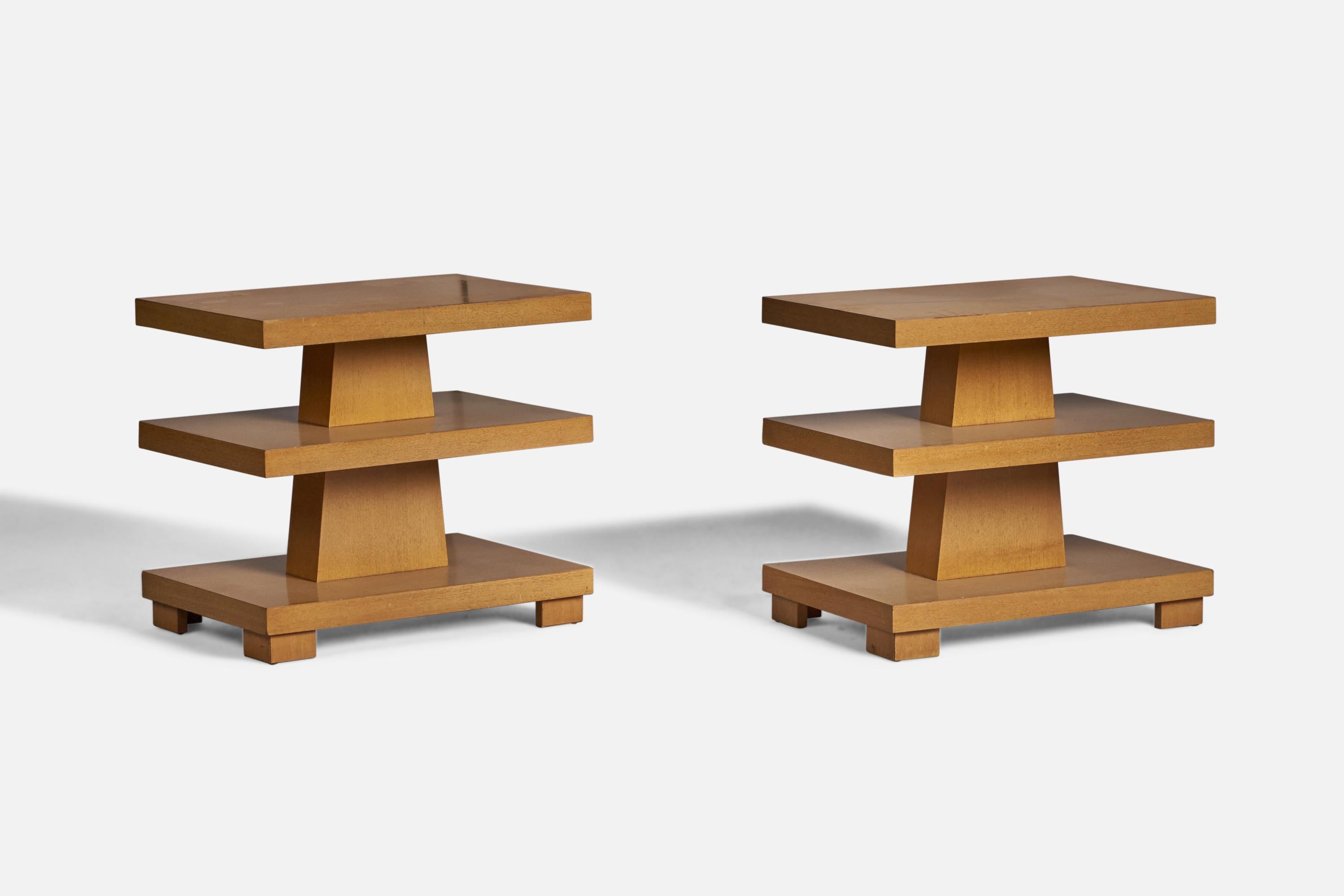 A pair of wood side tables designed and produced in the US, 1940s.