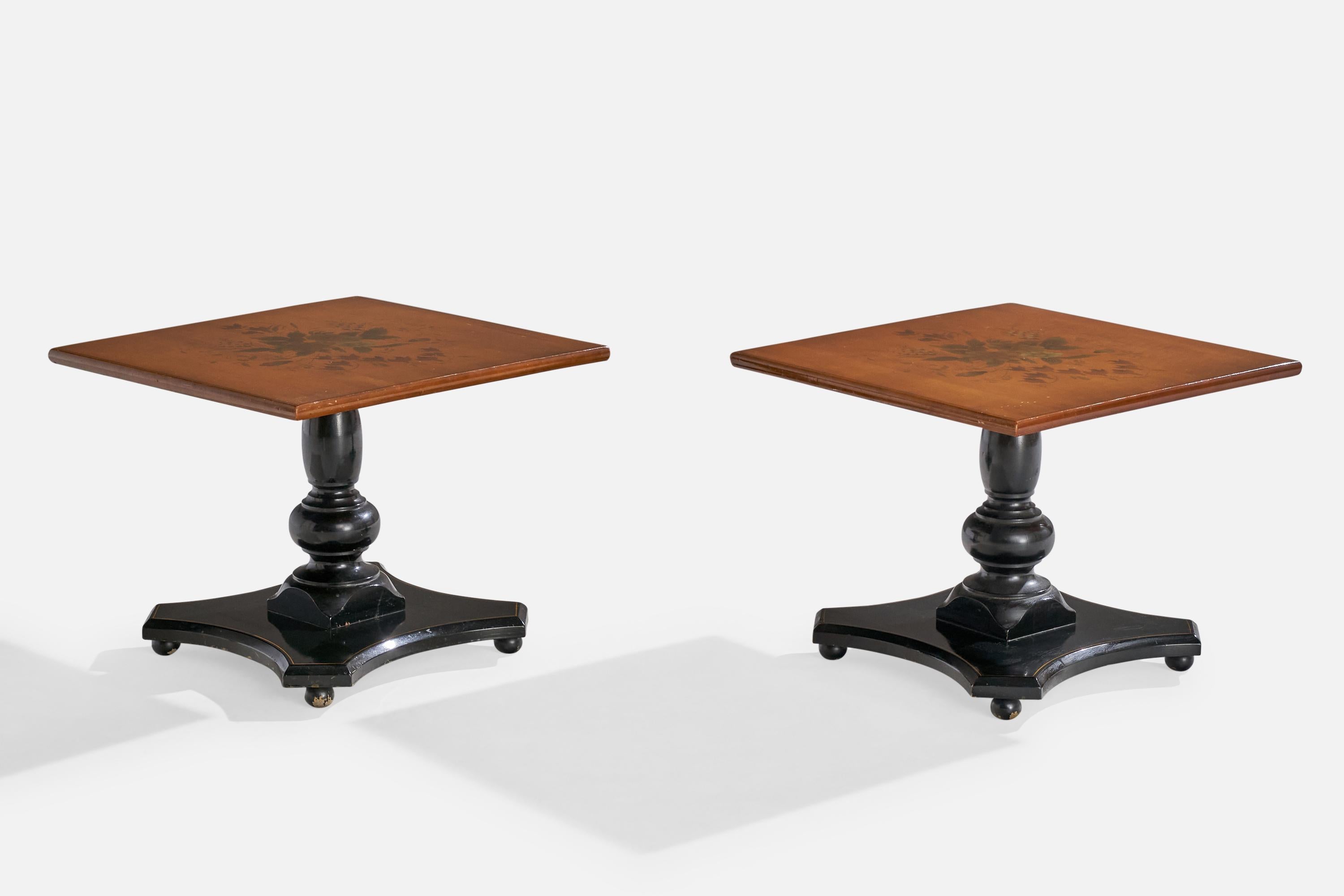 A pair of floral printed and black-lacquered wood side tables designed and produced in the US, c. 1940s.

Dimensions: 16” H x 20” W x 20