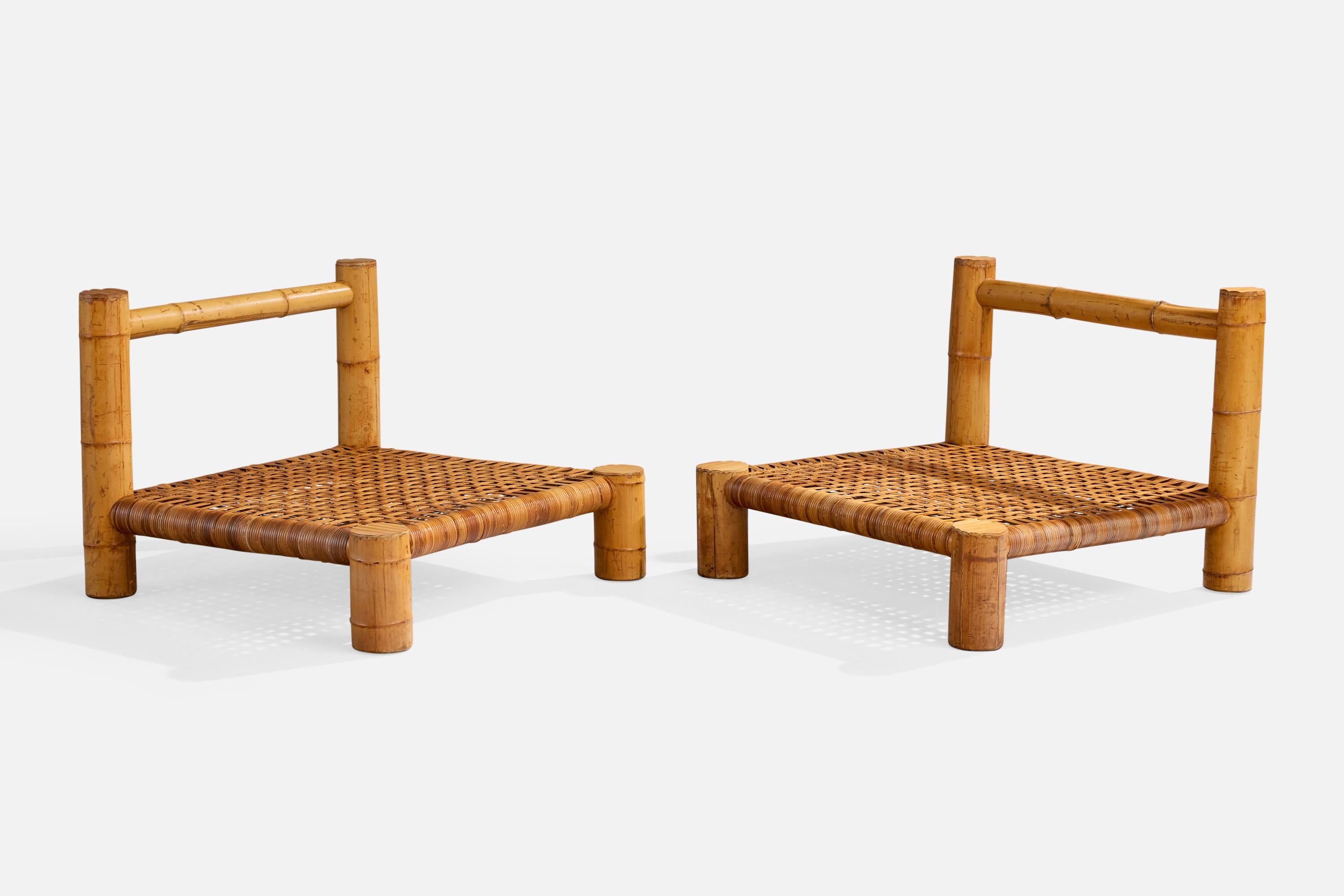 A pair of bamboo and rattan slipper or lounge chairs likely designed and produced in the US, c. 1970s.

Dry cracks present to bamboo. 

Likely originally configured with cushions.

Wear consistent with age and use

Overall Dimensions (inches):