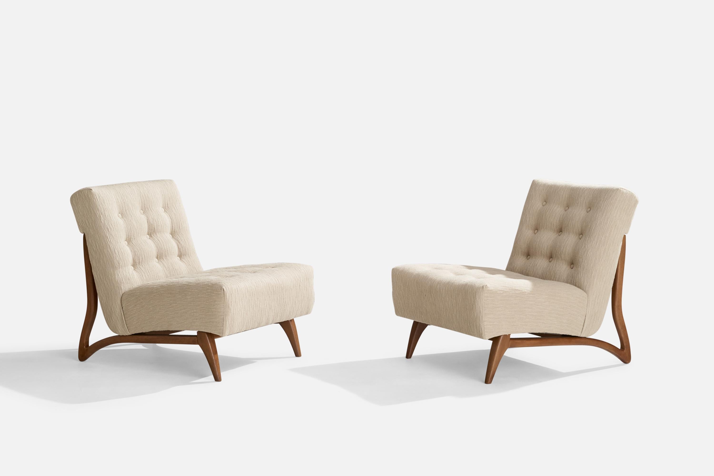 A pair of white fabric and walnut slipper lounge chairs designed and produced in the US, c. 1950s.

Seat height: 16.25”