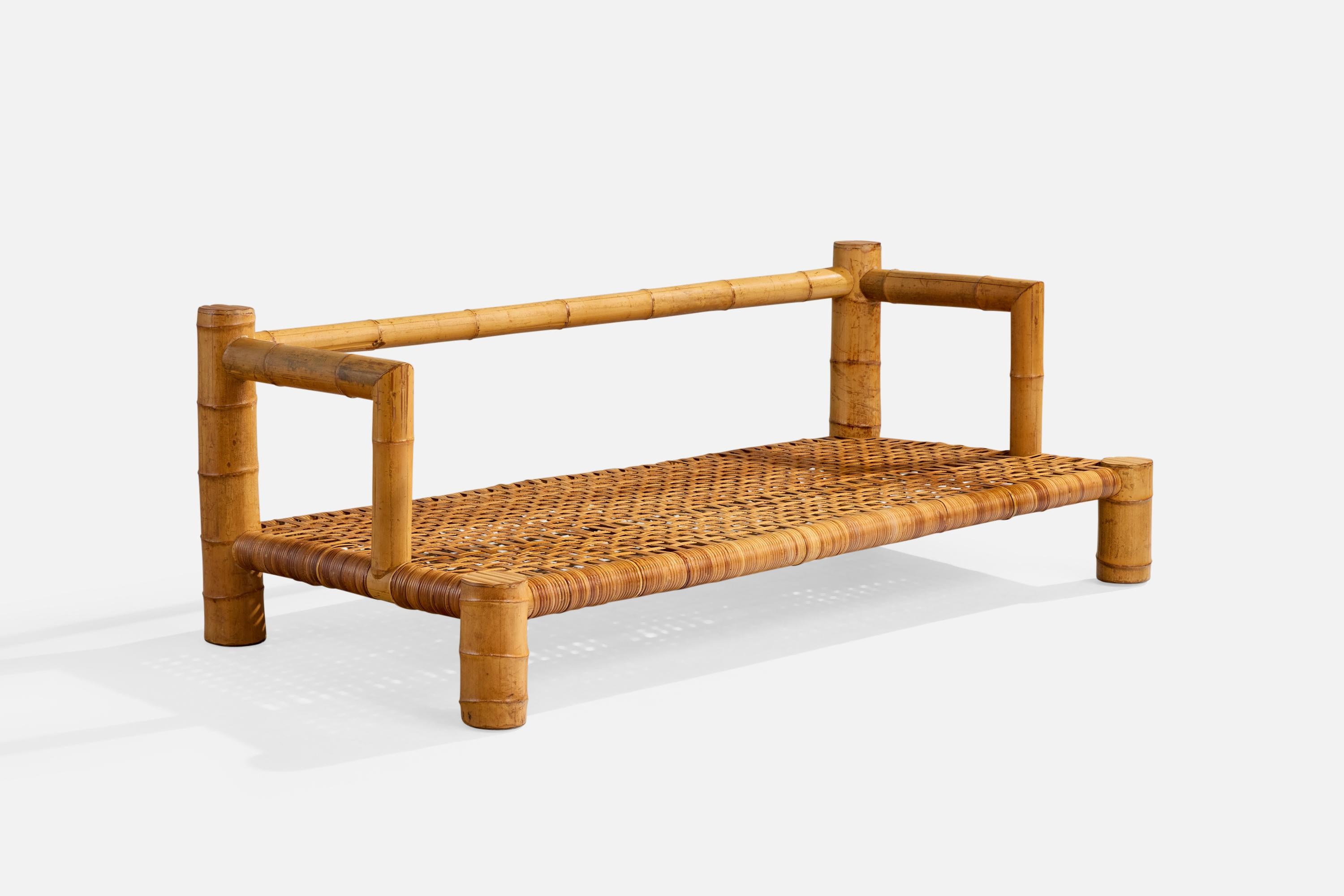 A bamboo and rattan sofa or bench likely designed and produced in the US, c. 1970s.

Splitting present to bamboo. 

Likely originally configured with cushions.

Wear consistent with age and use

Overall Dimensions (inches): 25.75