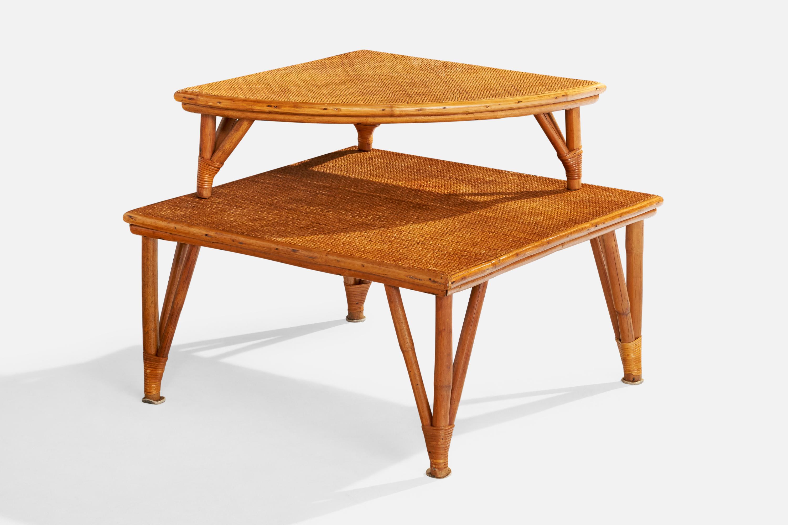 A set of two bamboo, rattan and cane stacking tables designed and produced in the US, c. 1950s.

Overall Dimensions: 24.375” H x 31” W x 31” D

Dimensions of Larger Table: 15.75” H x 31” W x 31” D

Dimensions of Smaller Table: 8.625” H x 25” W x 25”