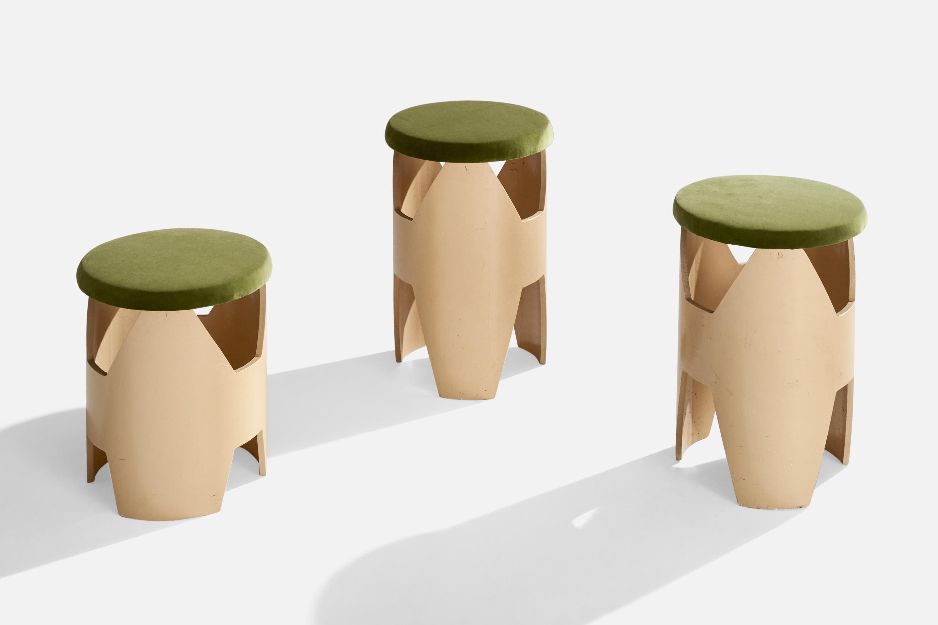 A set of three cream white plywood and green velvet stools designed and produced in the US, c. 1960s.

