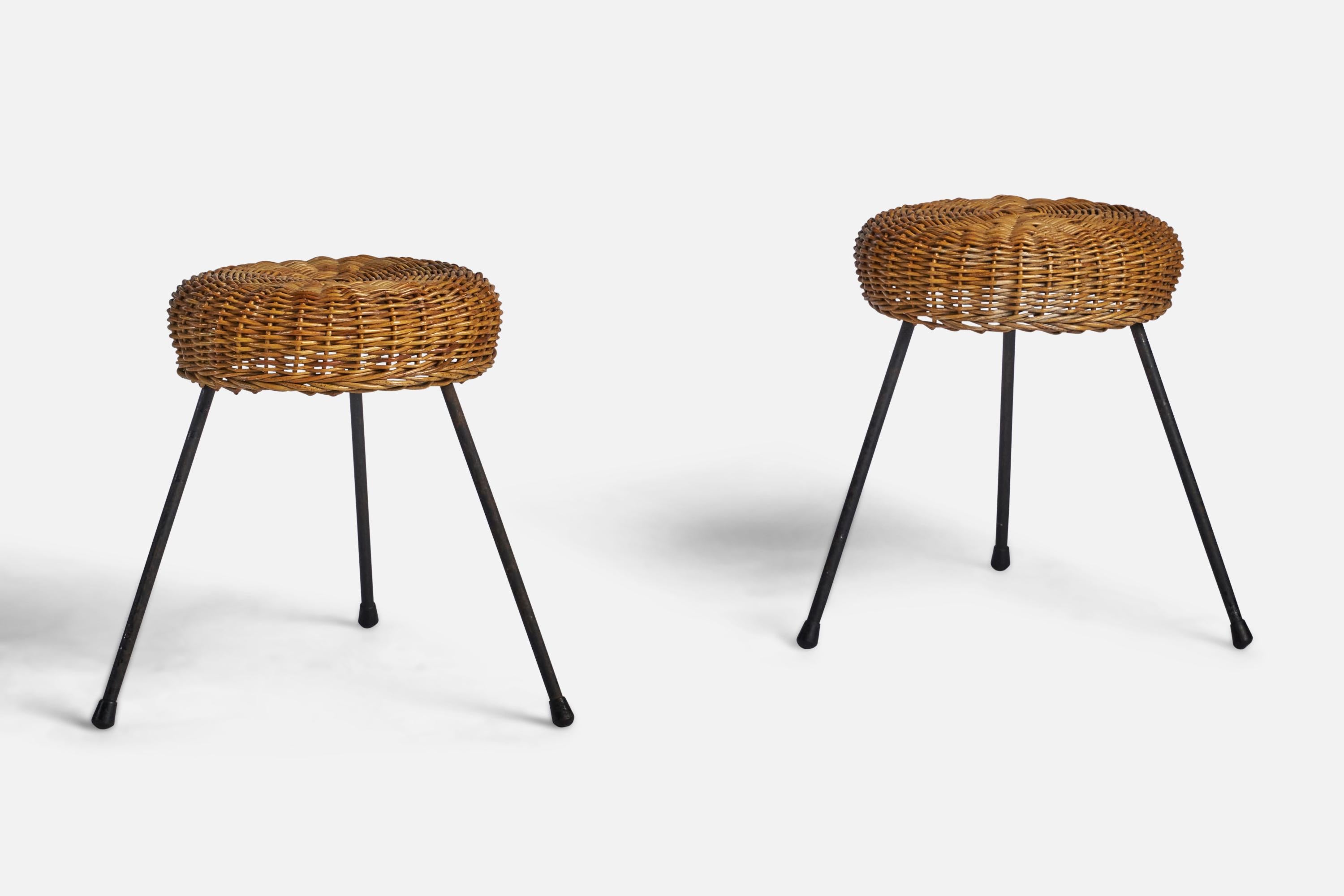 A pair of woven rattan and black-painted iron stools designed and produced in the US, c. 1950s.