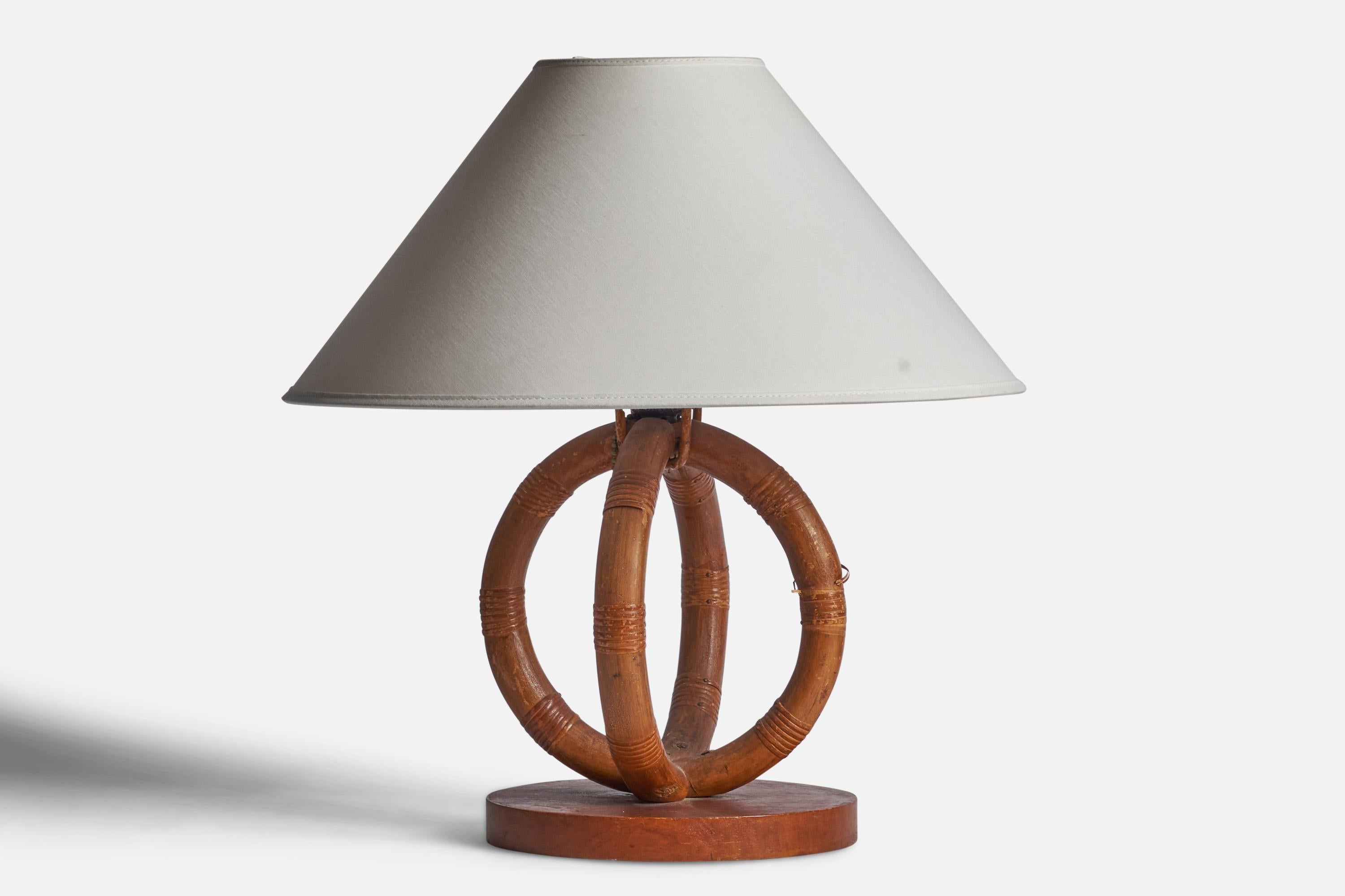 A moulded bamboo, rattan and wood table lamp designed and produced in the US, 1950s.

Dimensions of Lamp (inches): 12” H x 8” Diameter
Dimensions of Shade (inches): 4.5” Top Diameter x 16” Bottom Diameter x 9” H
Dimensions of Lamp with Shade