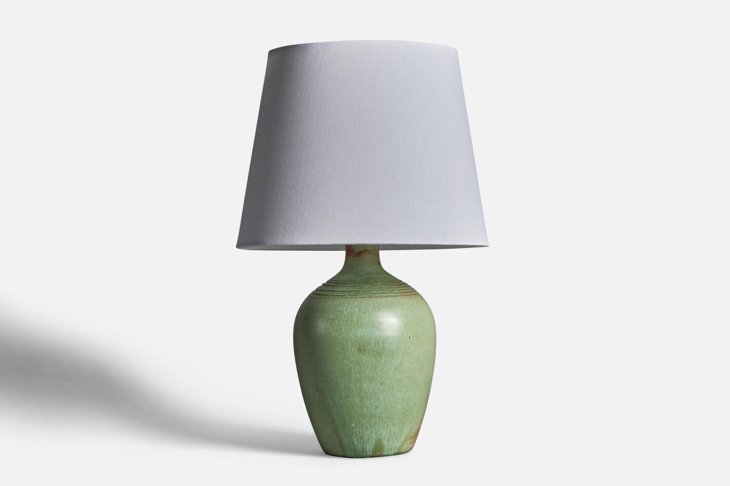 A green-glazed and incised ceramic table lamp designed and produced in North Carolina, USA, 1950s.

Dimensions of Lamp (inches): 12.5” H x 6” Diameter
Dimensions of Shade (inches): 7.5” Top Diameter x 10” Bottom Diameter x 8” H
Dimensions of Lamp