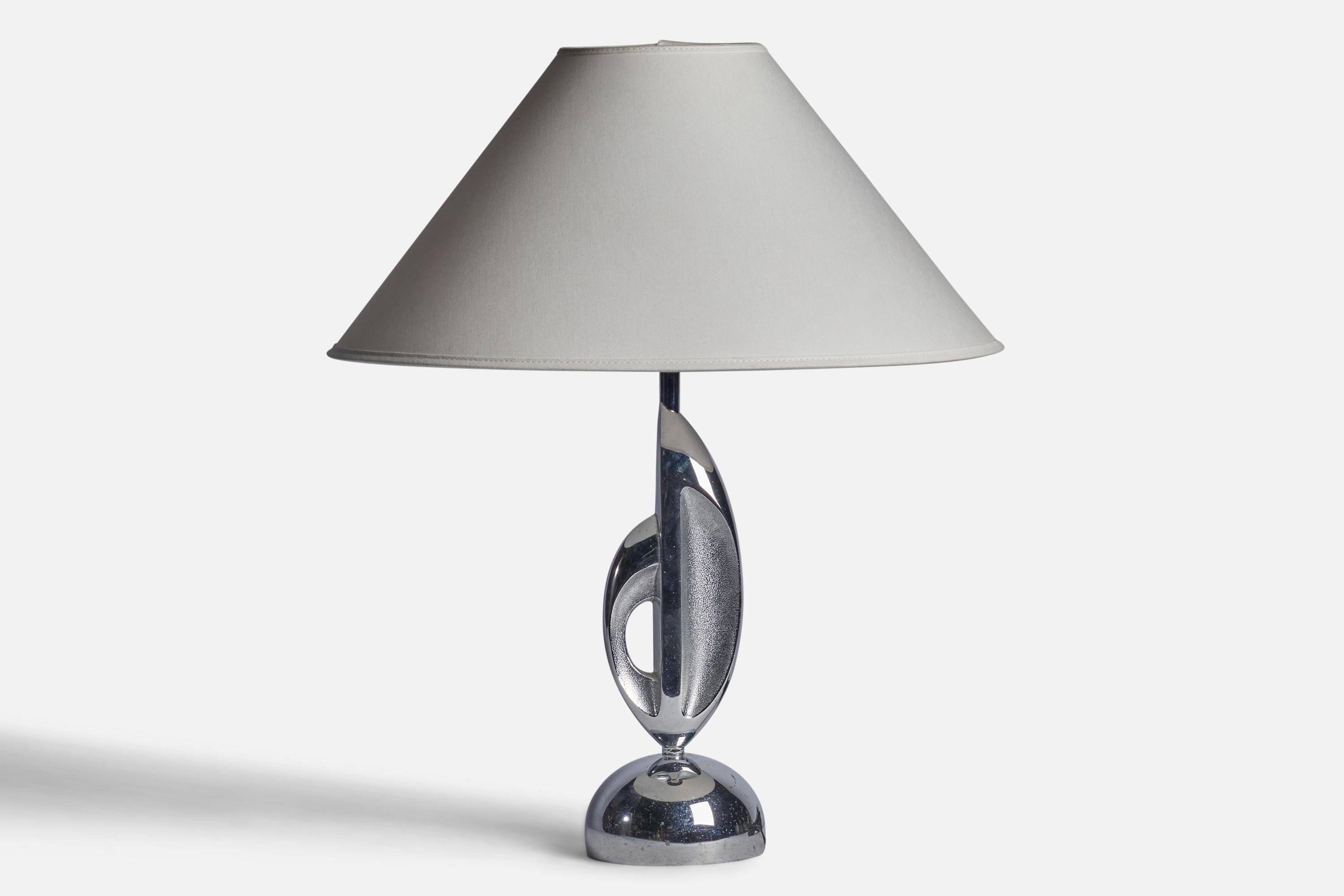 A chrome metal table lamp designed and produced in the US, c. 1930s.

Dimensions of Lamp (inches): 14.5” H x 4.25” Diameter
Dimensions of Shade (inches): 4.5” Top Diameter x 15.75” Bottom Diameter x 9” H
Dimensions of Lamp with Shade (inches): 19.5”