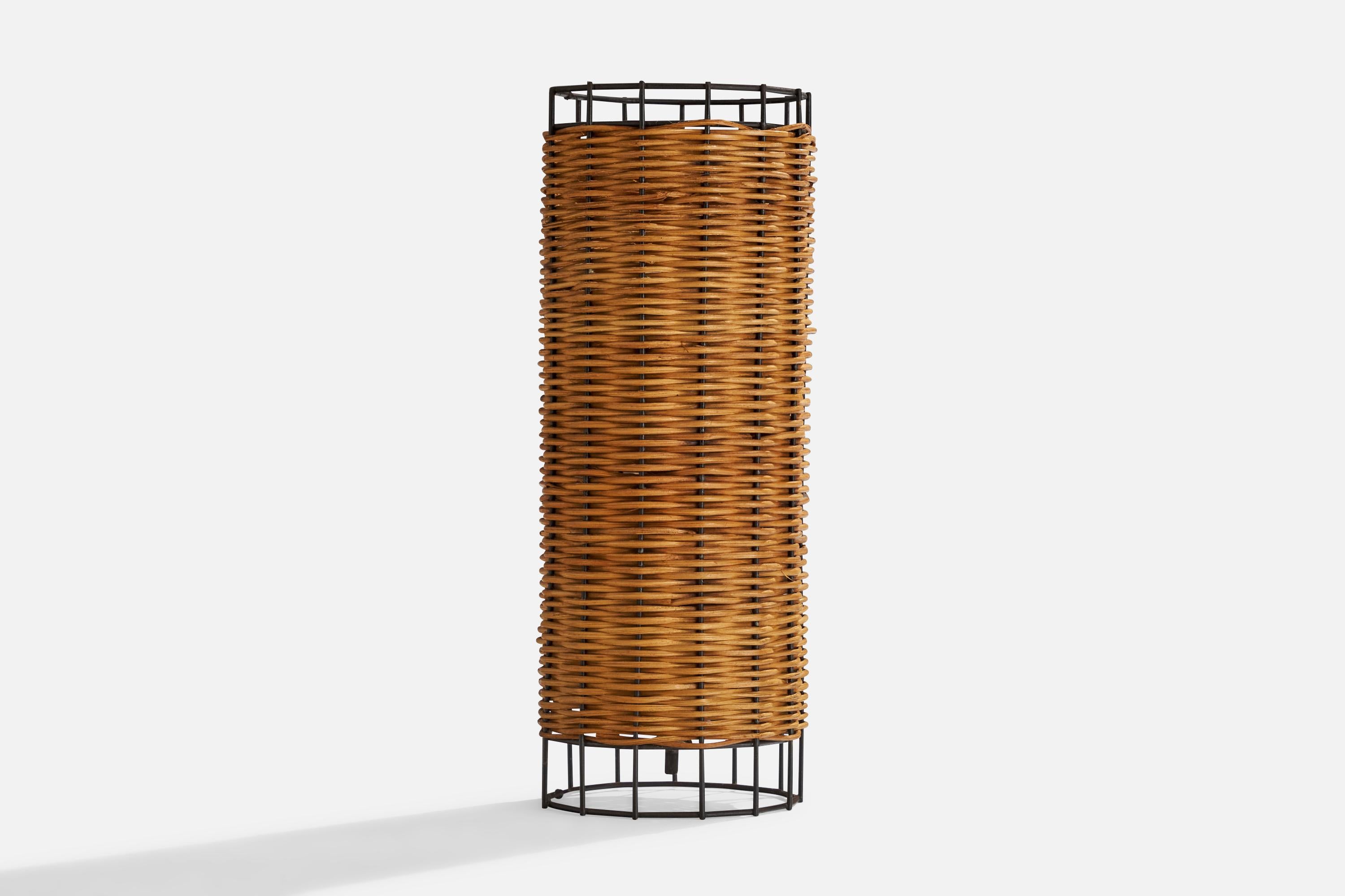 A rattan and black-lacquered metal table lamp designed and produced in the US, c. 1960s.

Overall Dimensions (inches): 12.25”  H x 4.5”  D
Stated dimensions include shade.
Bulb Specifications: E-26 Bulb
Number of Sockets: 1
All lighting will be