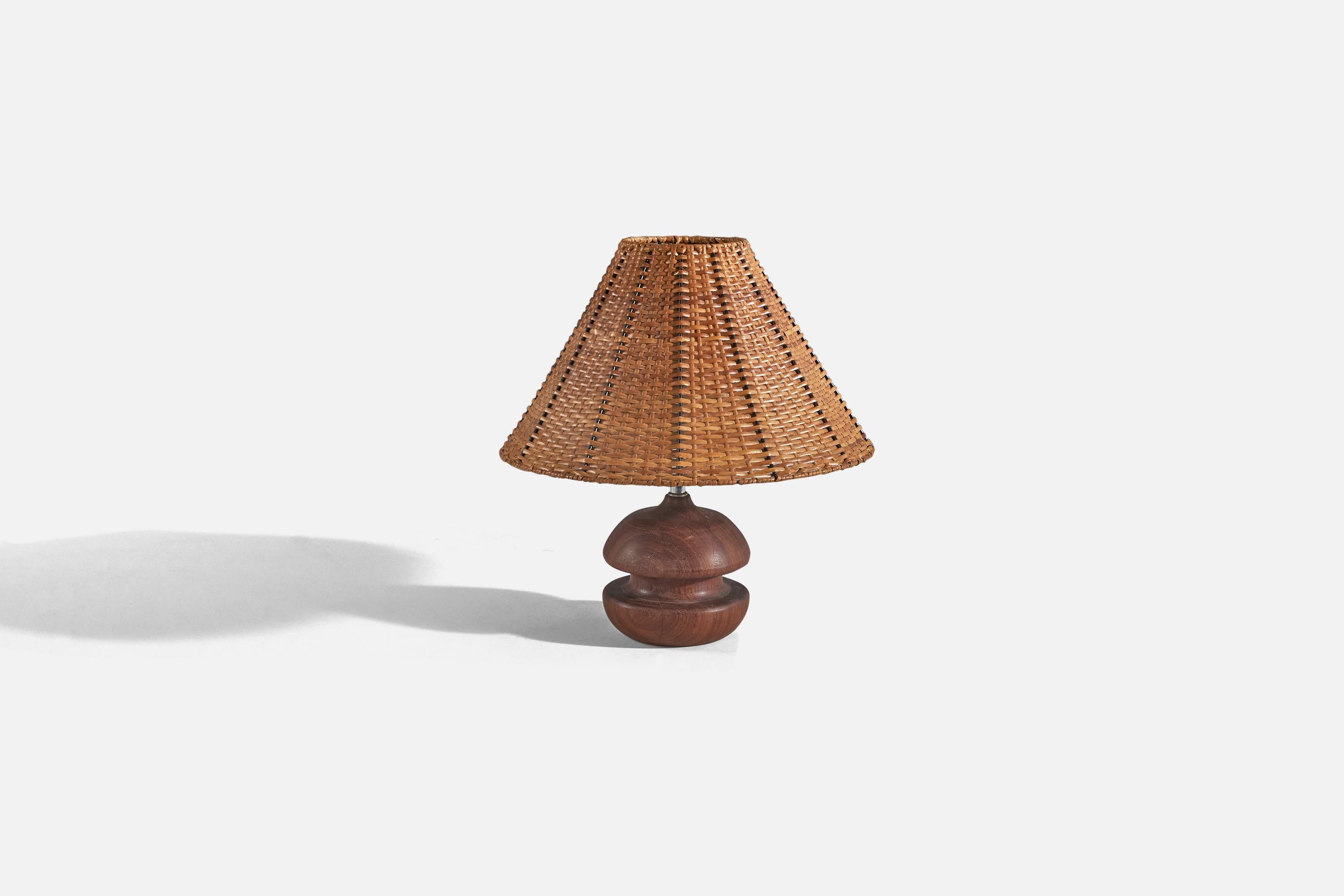 A teak, brass and rattan table lamp designed and produced by an American designer, 1960s. 

Sold with lampshade. 
Dimensions of lamp (inches) : 10.5 x 6.06 x 6.06 (H x W x D)
Dimensions of shade (inches) : 5 x 15 x 10 (T x B x S)
Dimension of