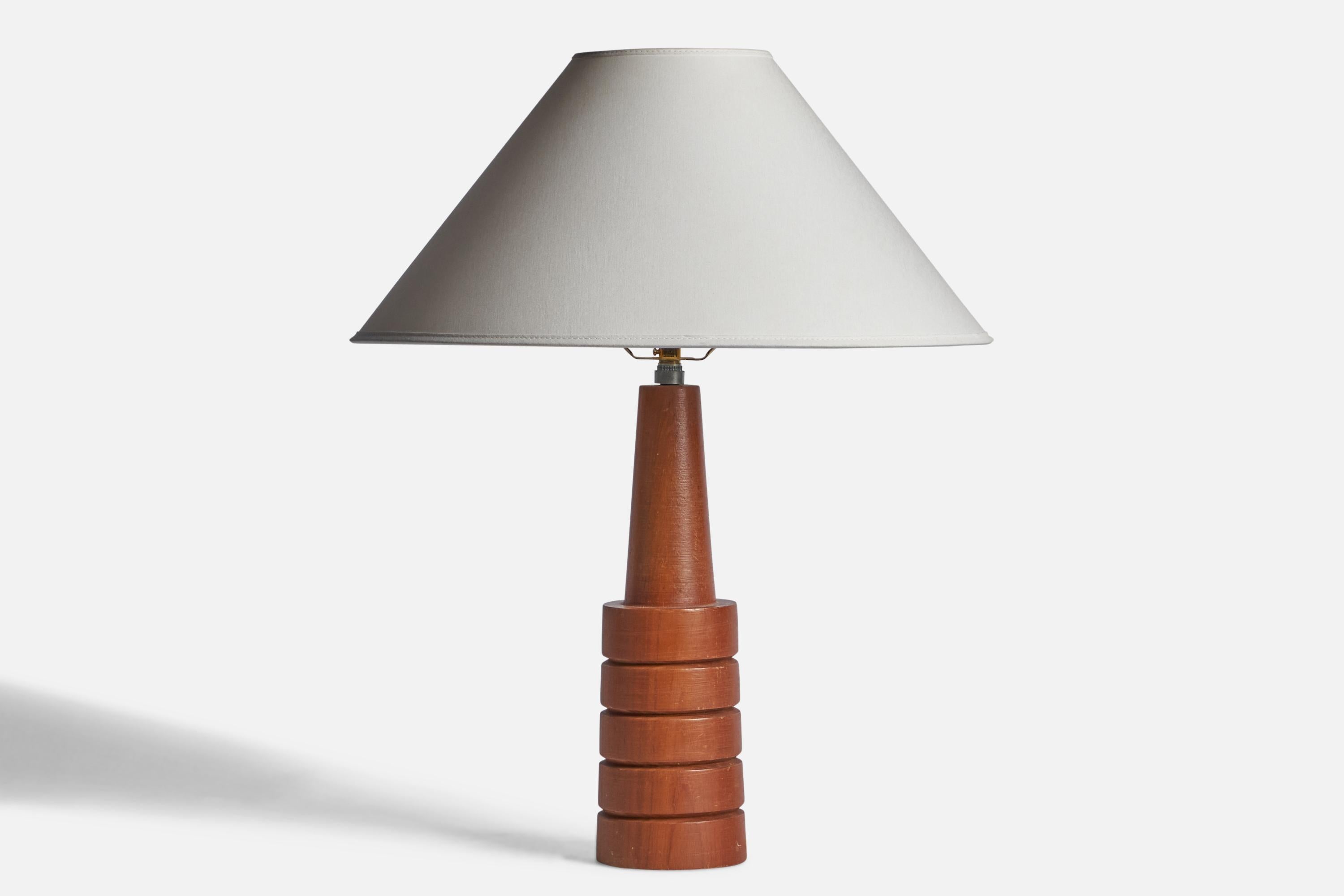 A teak table lamp designed and produced in the US, c. 1960s.

Dimensions of Lamp (inches): 15.25” H x 3.75” Diameter
Dimensions of Shade (inches): 4.5” Top Diameter x 16” Bottom Diameter x 7.15” H 
Dimensions of Lamp with Shade (inches): 19.75” H x
