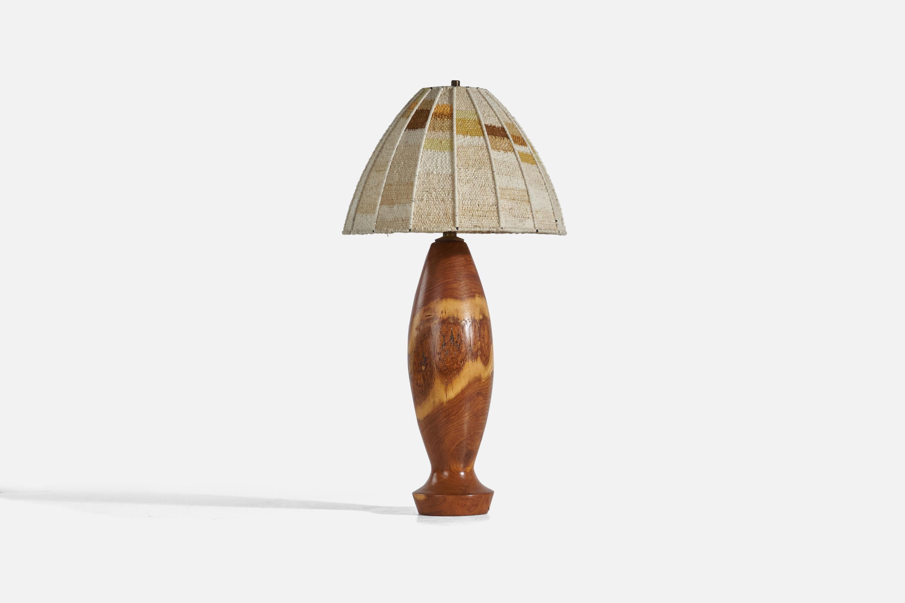 A wood and fabric table lamp designed and produced in the United States, c. 1950s. With its original handwoven lampshade.

Sold with Lampshade. Dimensions stated are of Table Lamp with Lampshade. 

Socket takes standard E-26 medium base bulb.

There