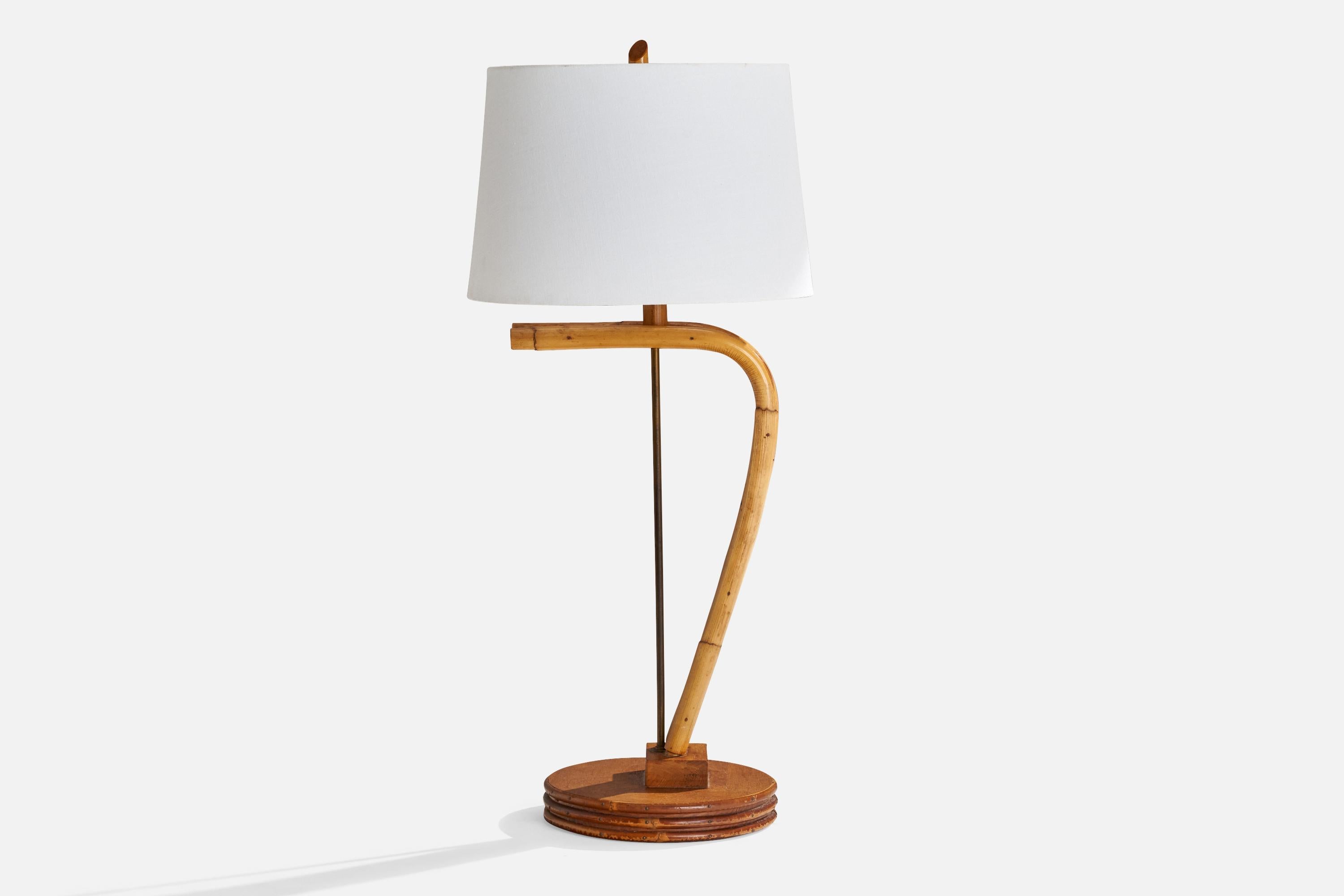 A moulded bamboo, brass and wood table lamp designed and produced in the US, c. 1950s.

Dimensions of Lamp (inches): 26.5” H x 10.5” Diameter
Dimensions of Shade (inches): 13” Top Diameter x 15” Bottom Diameter x 10” H
Dimensions of Lamp with Shade