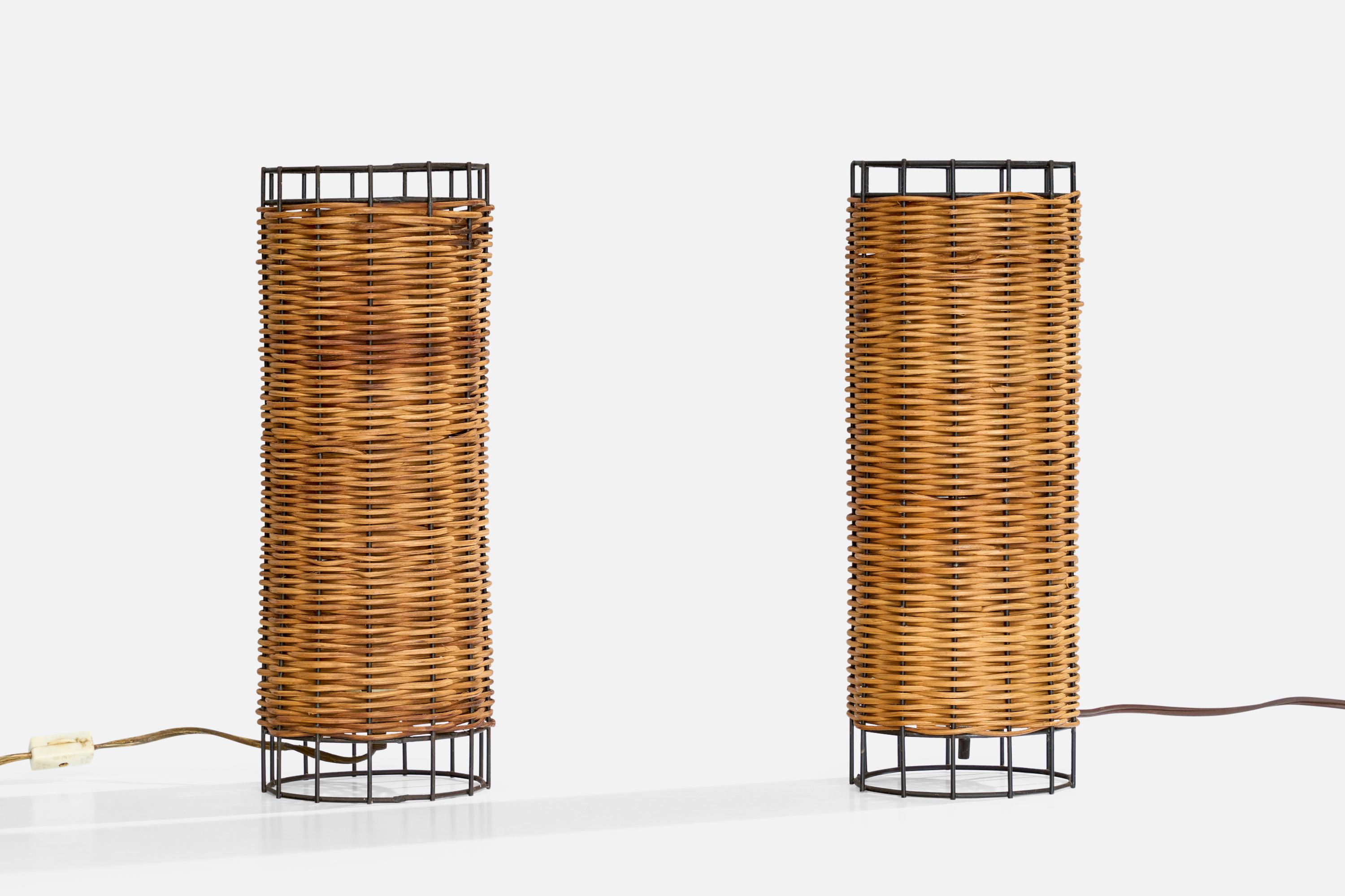 A pair of black-lacquered metal and cane table lamps designed and produced in the US, c. 1960s.

Dimensions of Lamp with Shade (inches): 12“ H x 4.6” Diameter

Bulb Specifications: E-26 

Number of Sockets (per fixture): 1

All lighting will be