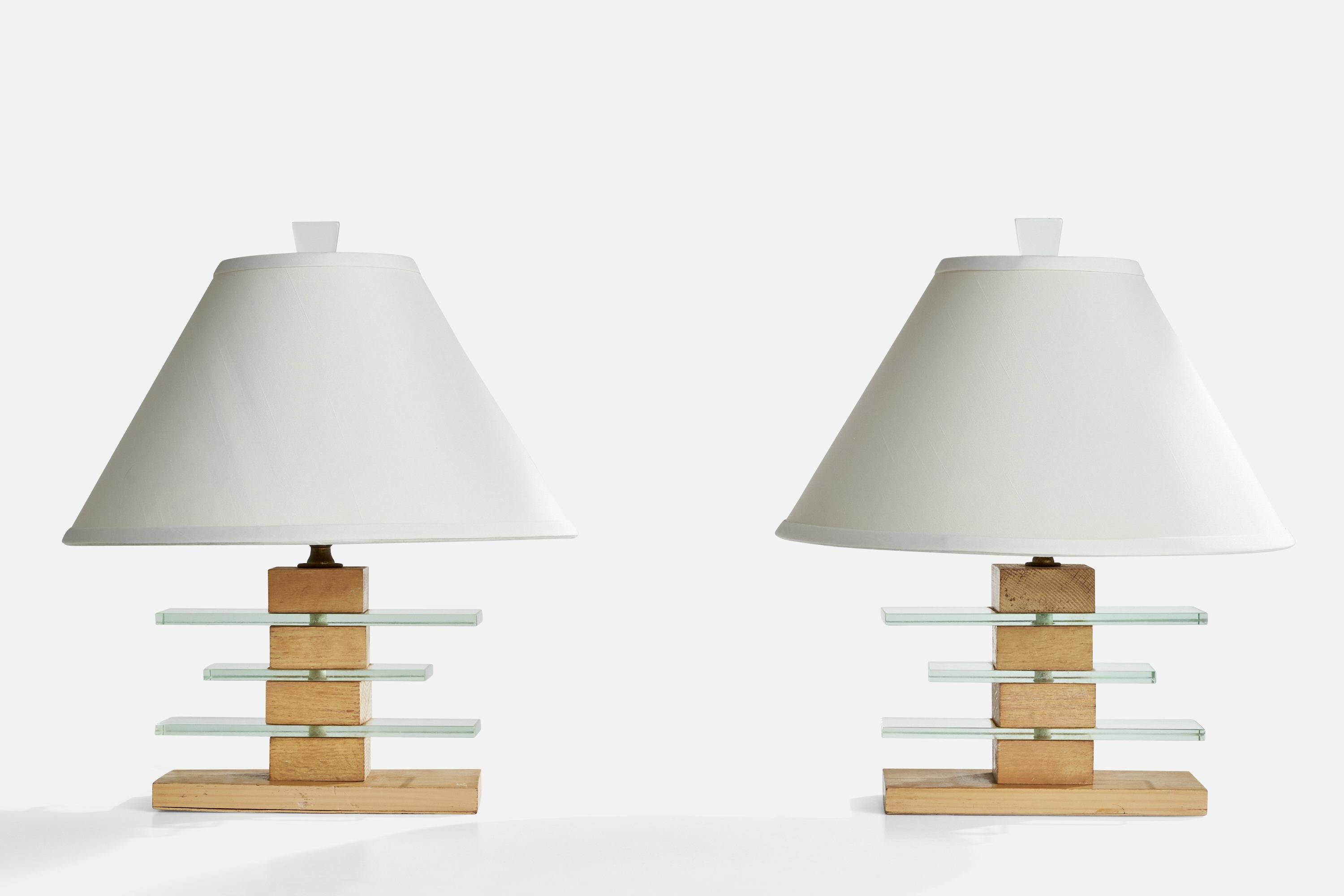 A pair of oak, glass and brass table lamps designed and produced in the US, c. 1950s.

Dimensions of Lamp (inches): 18.25“ H x 10” W x 5” D

Dimensions of Shade (inches): 6“ Top Diameter x 16“ Bottom Diameter x 10.125“ H

Dimensions of Lamp with
