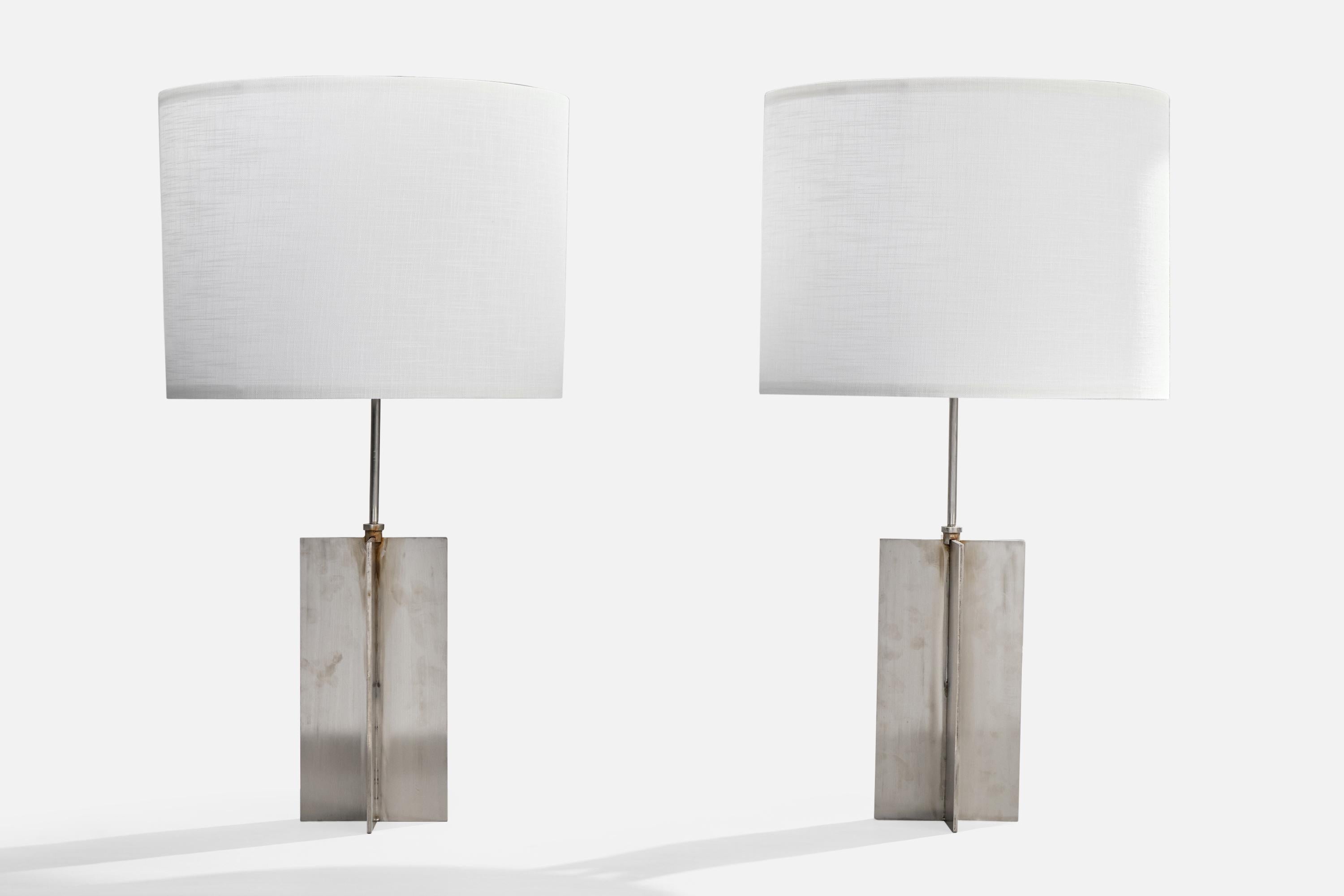 A pair of steel table lamps designed and produced in the US, c. 1960s.

Light discoloration to lamp consistent with age and use. 

Dimensions of Lamp (inches): 23“ H x 5.875” W x 5.875“ D

Dimensions of Shade (inches): 10” Top Diameter x 14“ Bottom