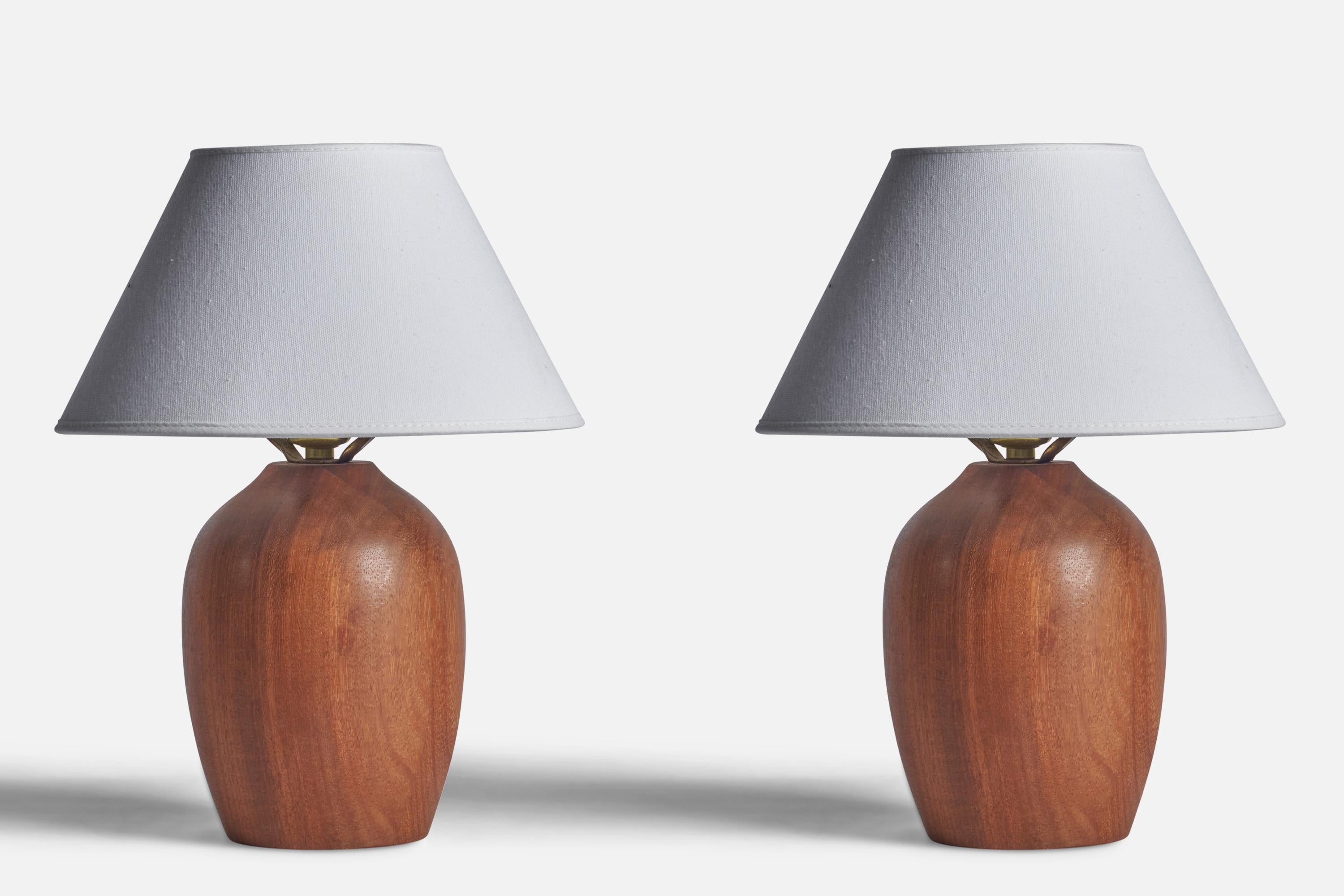 A pair of teak table lamps designed and produced in the US, 1950s.

Dimensions of Lamp (inches): 9.75” H x 5.35” D
Dimensions of Shade (inches): 4.5” Top Diameter x 10” Bottom Diameter x 5.25” H 
Dimensions of Lamp with Shade (inches): 13.2” H x 10”