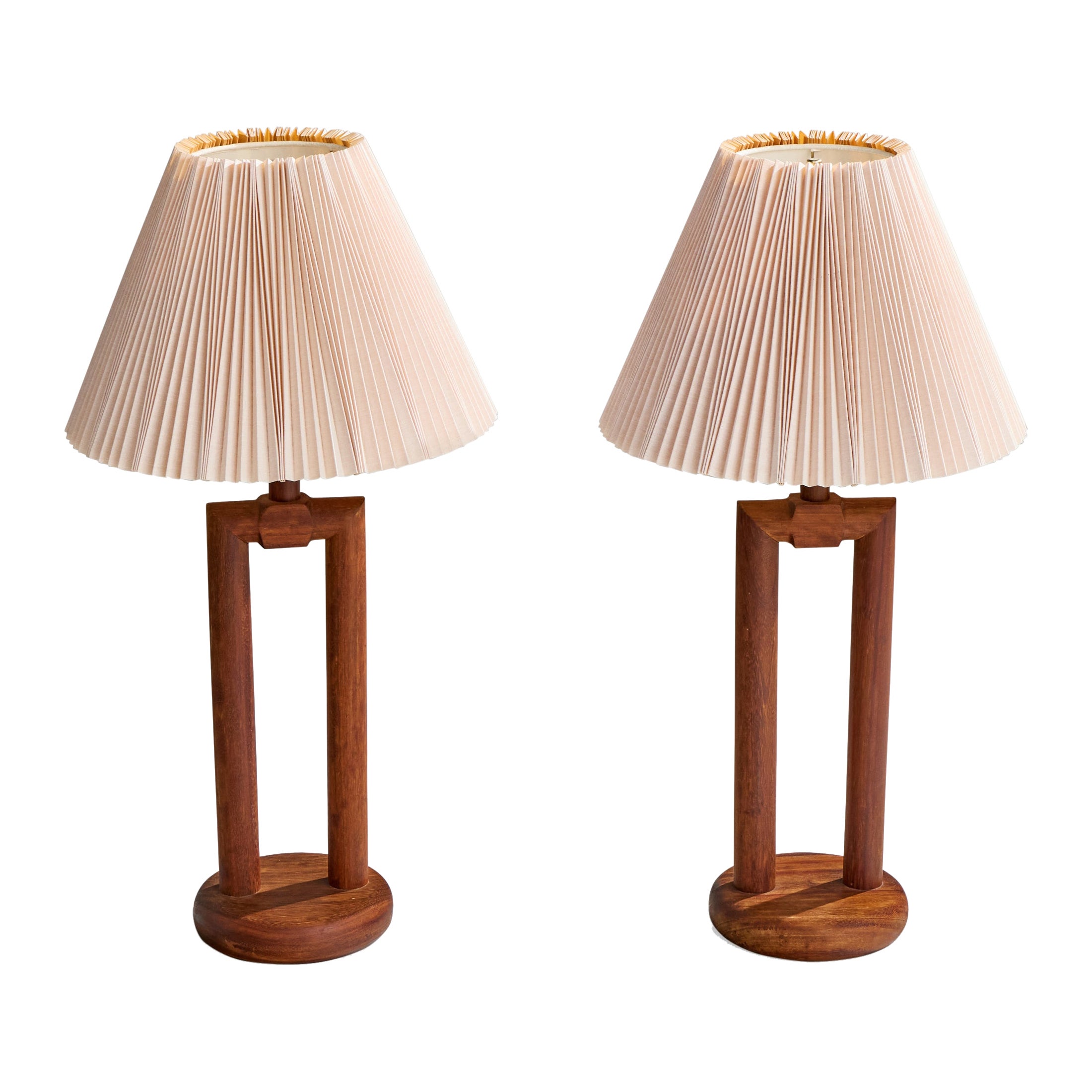 A pair of stained wood and light pink paper table lamps designed and produced in the US, c. 1950s.

Wear consistent with age and use

Overall Dimensions (inches): 35.5