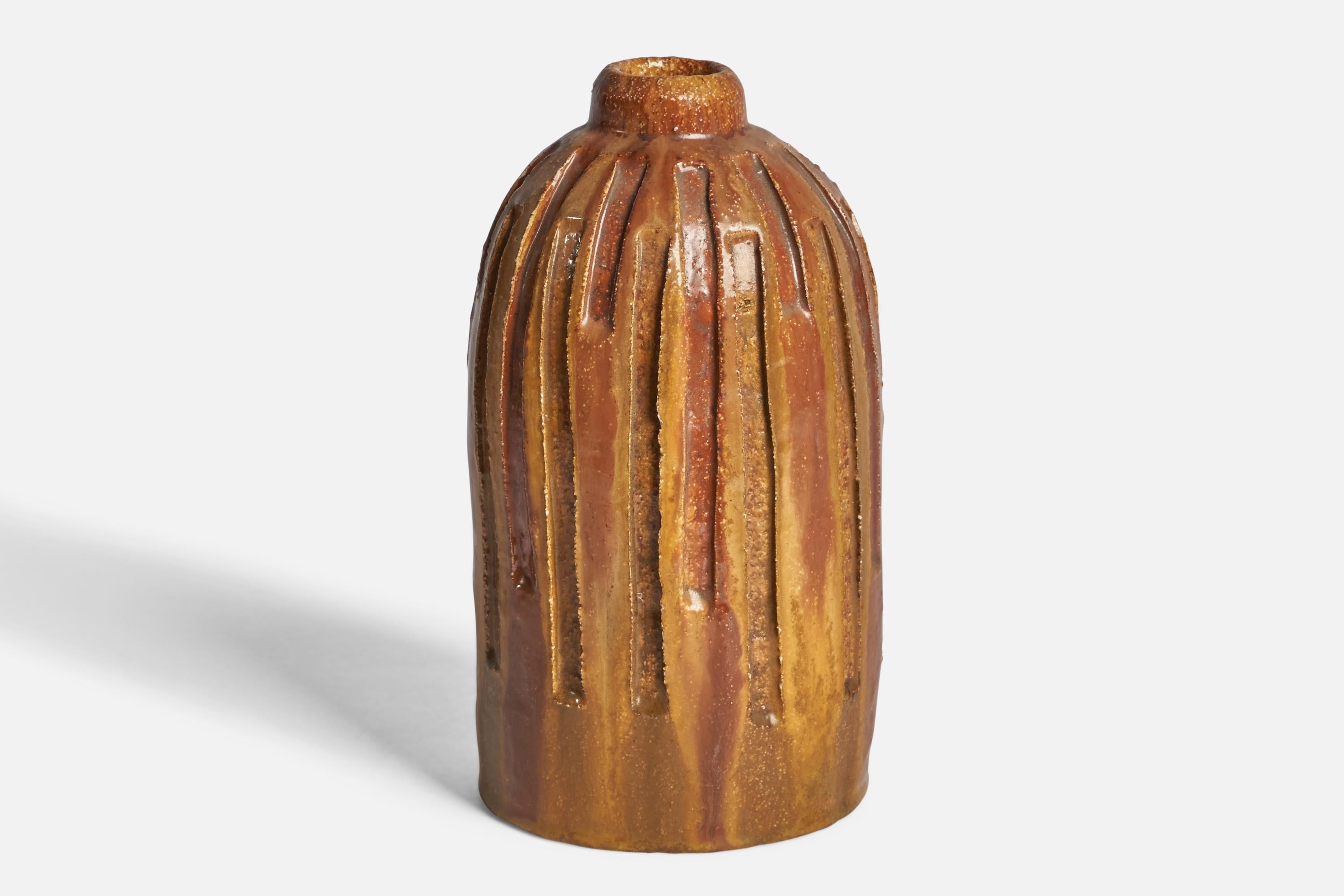A brown yellow-glazed ceramic vase designed and produced in the US, 1960s.