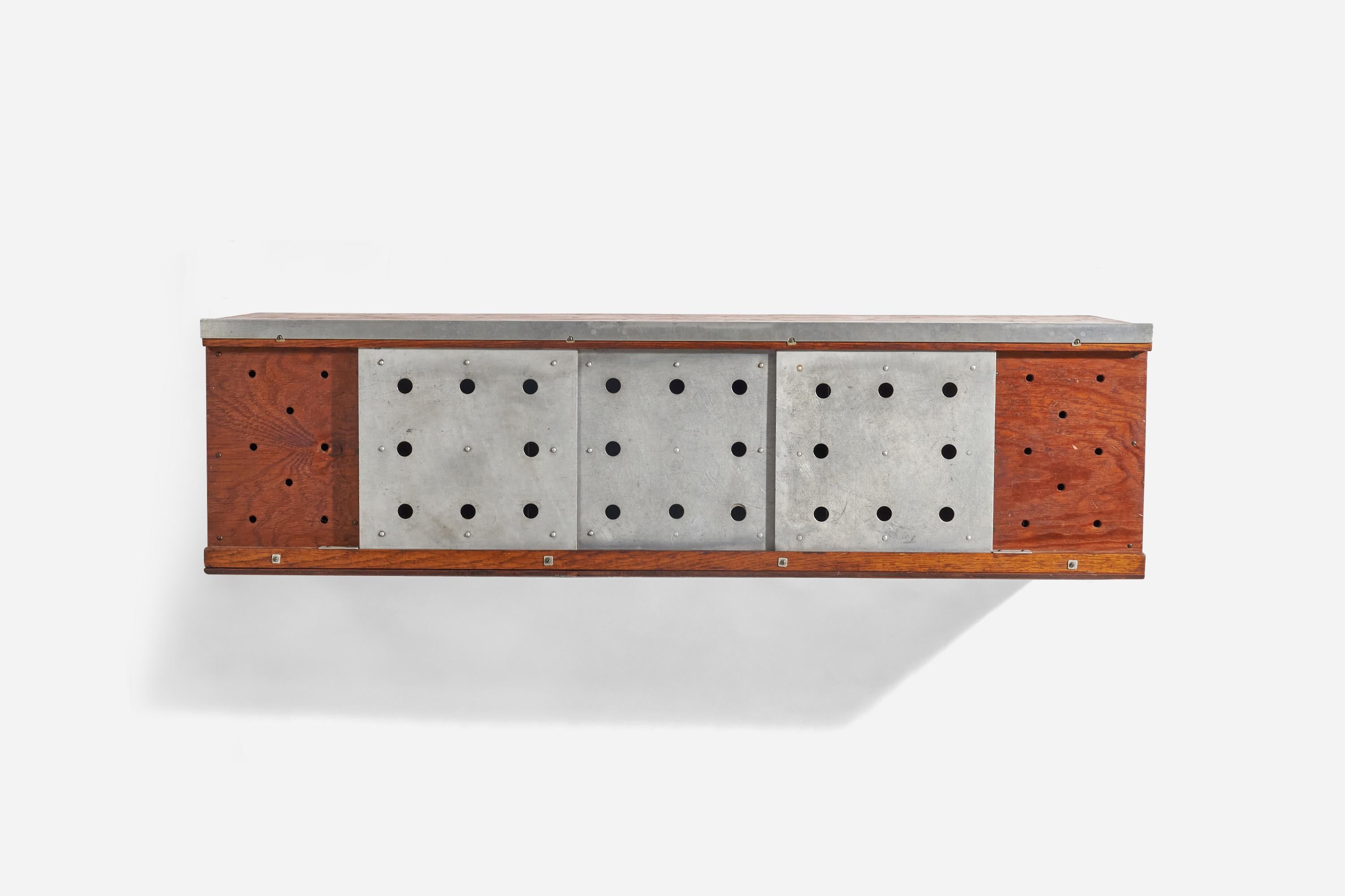 An oak and metal wall hanging cabinet designed and produced in the United States, 1960s.
