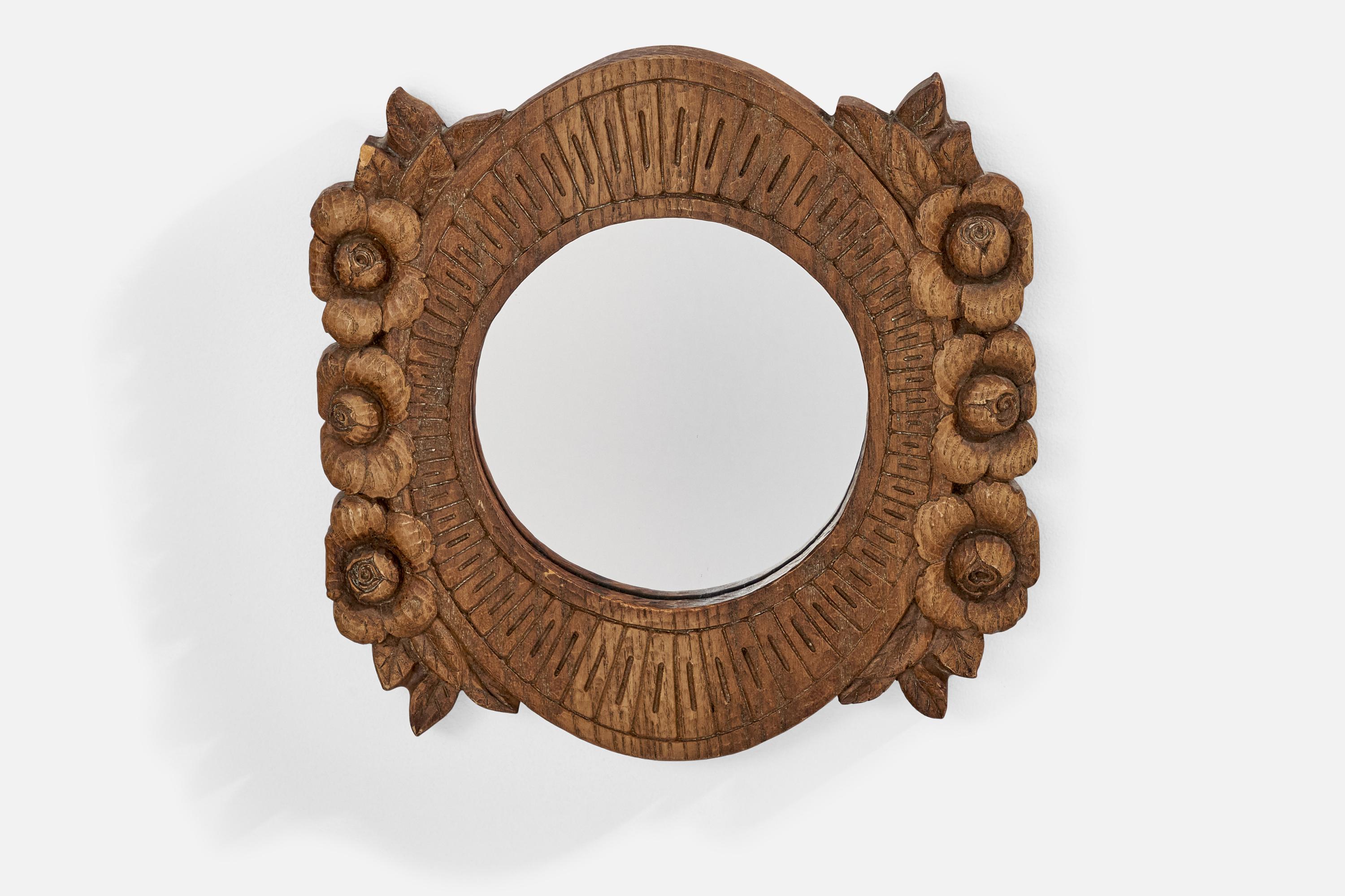 A hand-carved wood wall mirror designed and produced in the US, 1950s.

