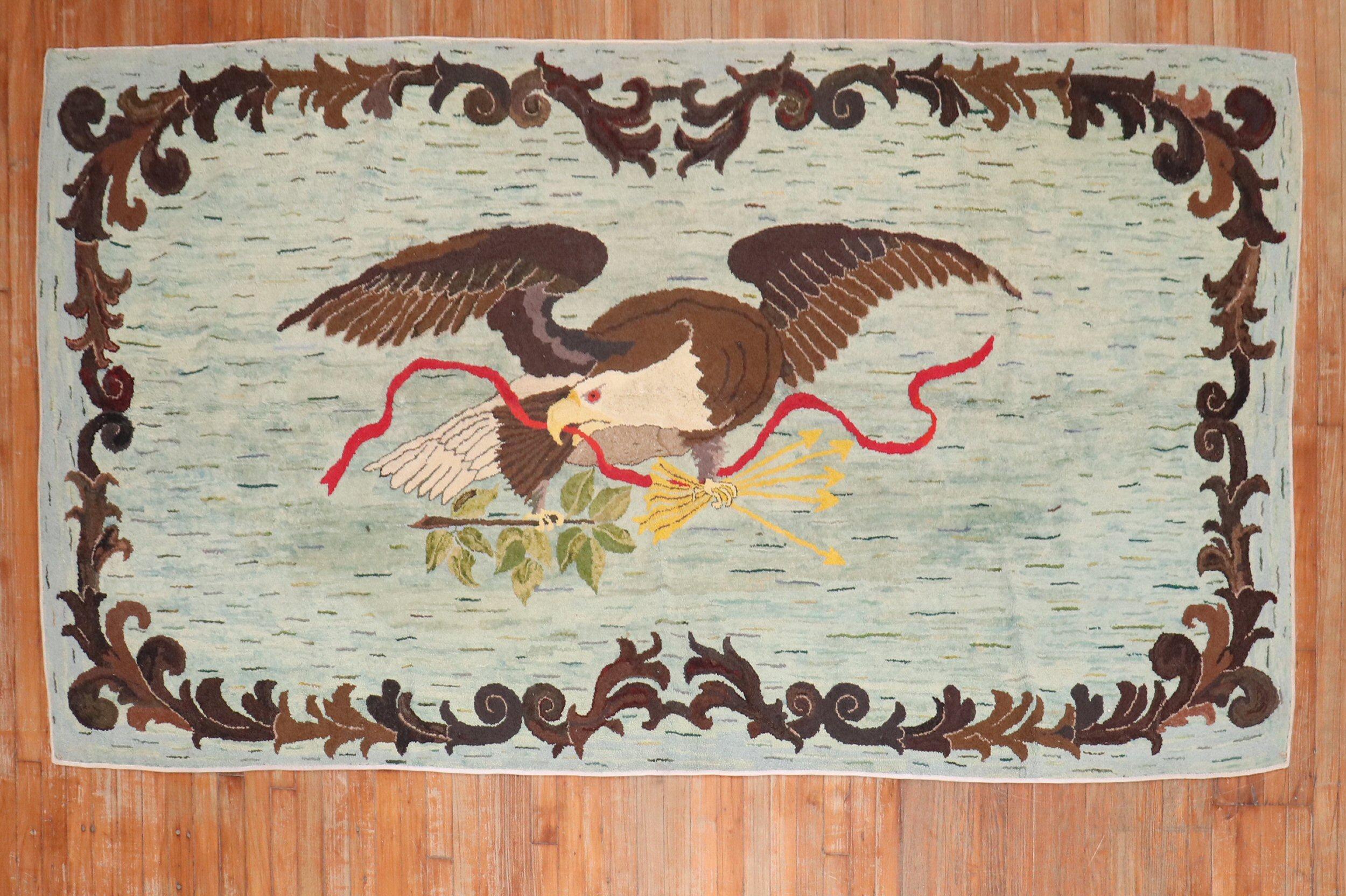 A handmade American Hooked rug from the 3rd quarter of the 20th century showing an American eagle on a turquoise field

Measures: 4'10'' x 9'2''.
