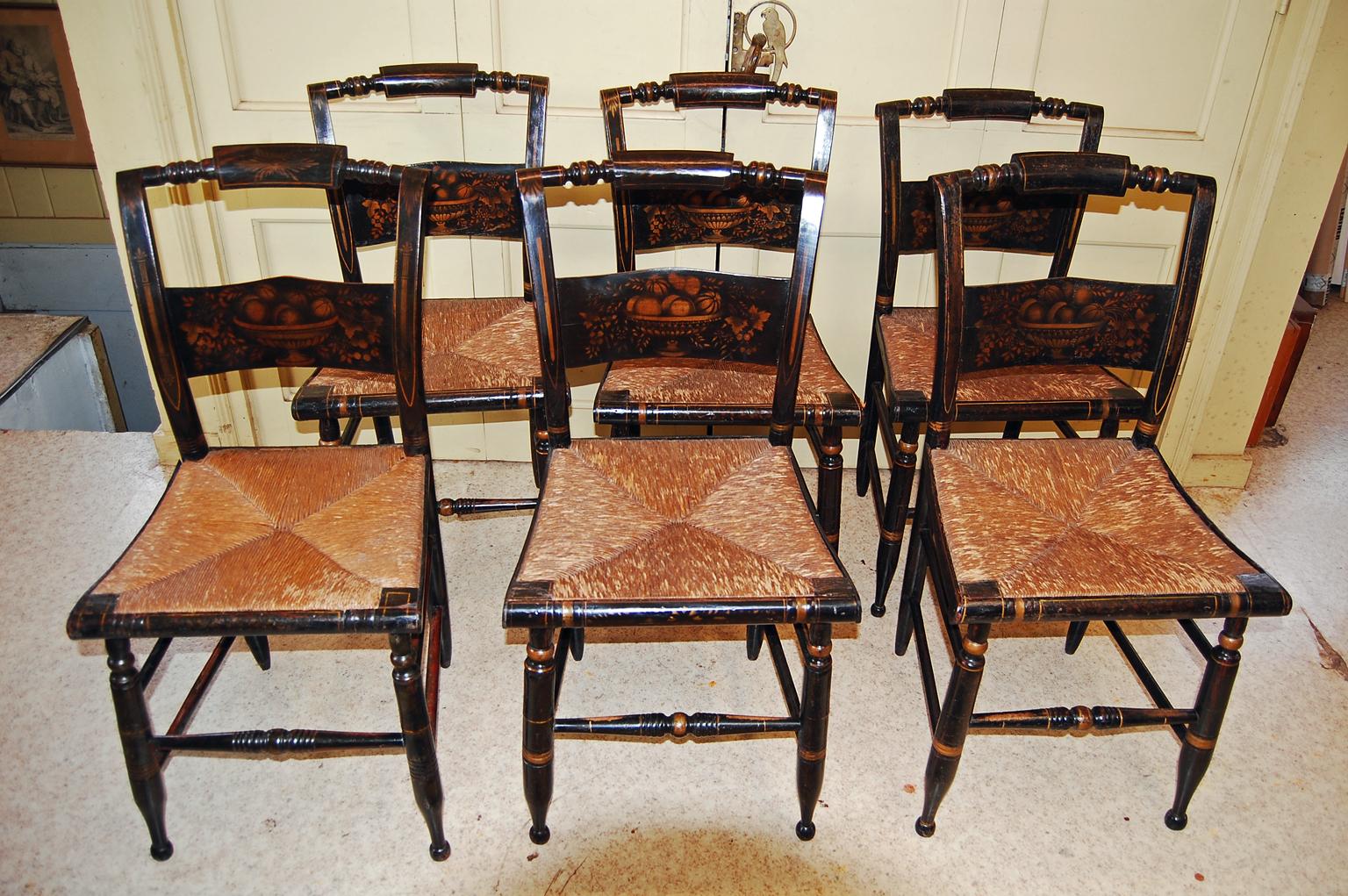   American set of six Hitchcock type chairs with original stenciled back, grain and line painted surface.  These rush seated chairs were inspired by the Hitchcock factory  (established 1818) and were a very popular chair from the early 19th through