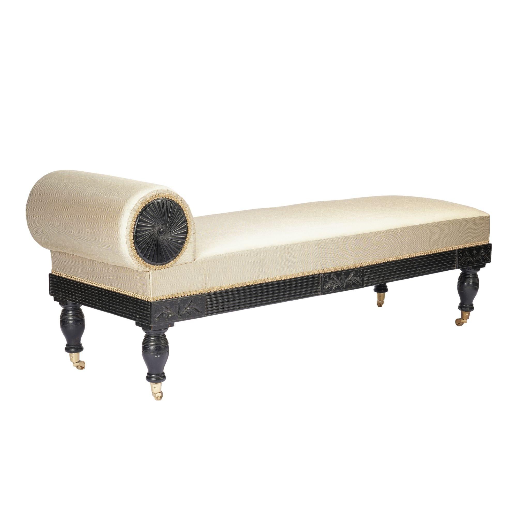 Brass American Eastlake upholstered chaise in ebonized walnut with brass casters, 1888 For Sale