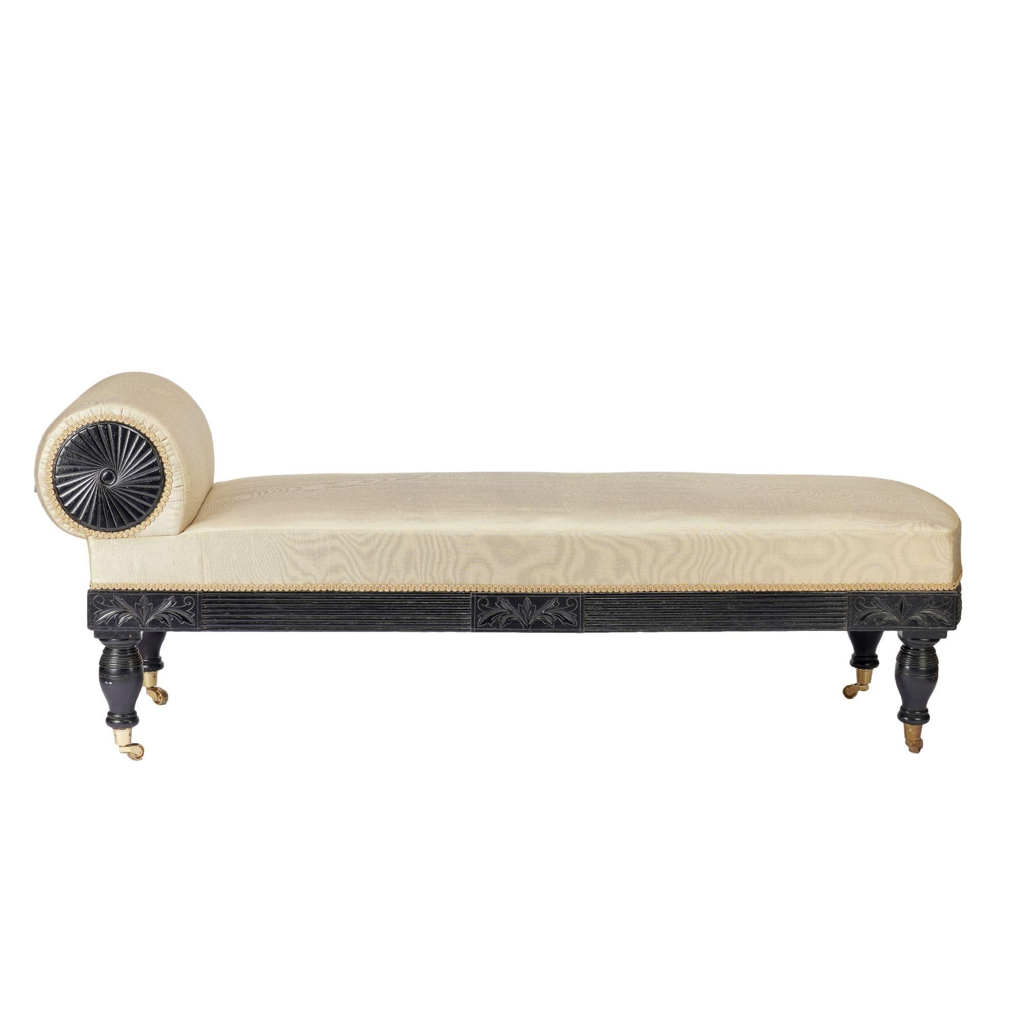 American Eastlake upholstered chaise in ebonized walnut with brass casters, 1888 For Sale 1