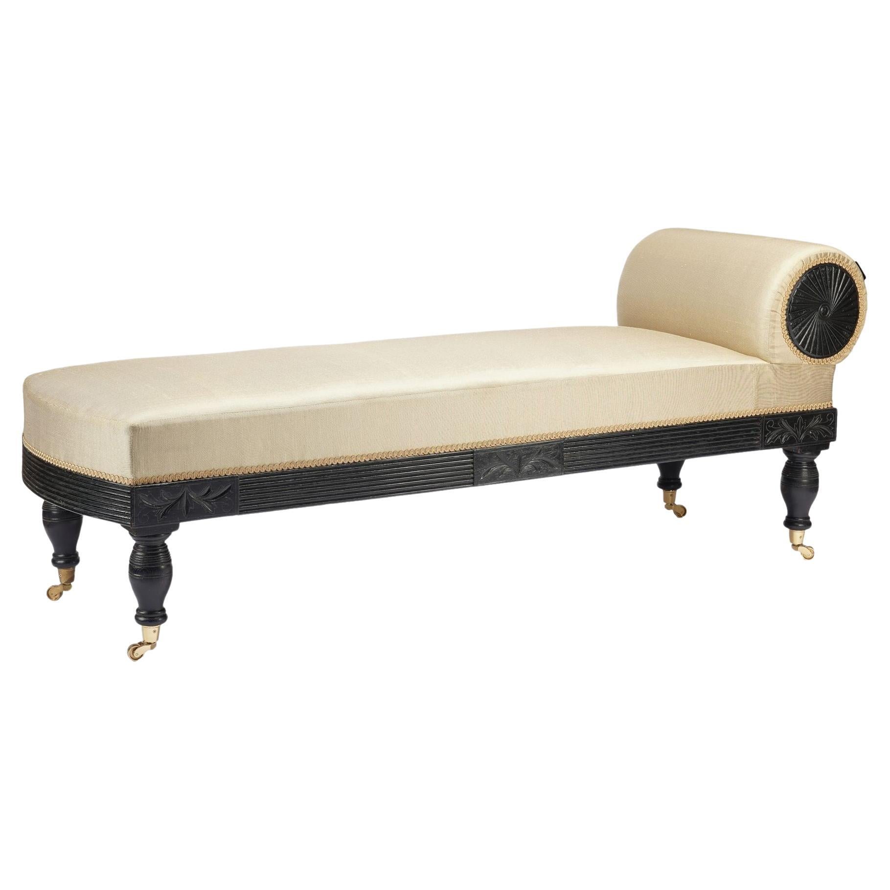 American Eastlake upholstered chaise in ebonized walnut with brass casters, 1888