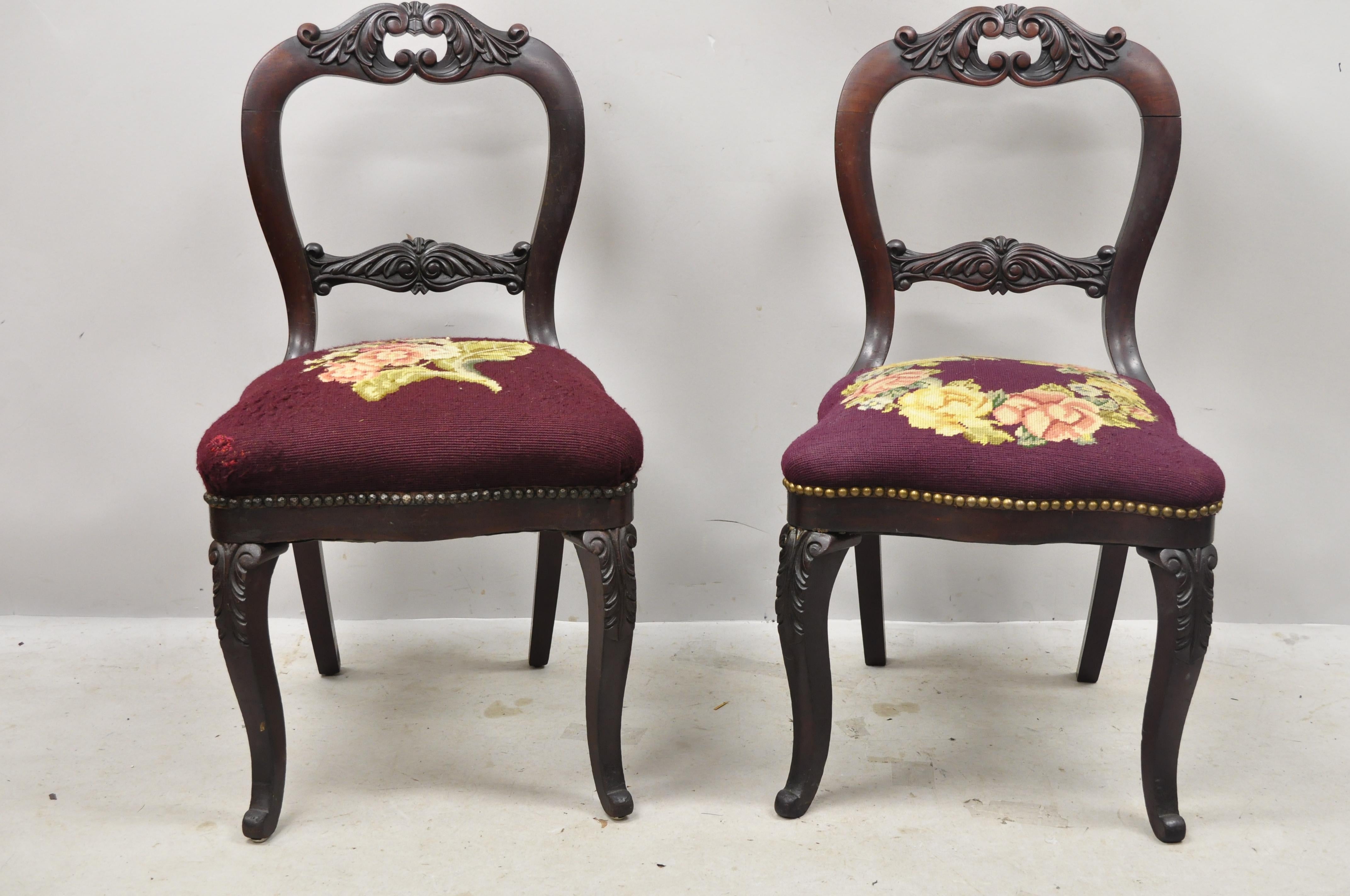 Antique American Eastlake Victorian carved mahogany floral needlepoint side chairs - a pair. Item features floral needlepoint upholstery, solid wood frame, nicely carved details, very nice antique pair, circa late 19th century. Measurements: 34