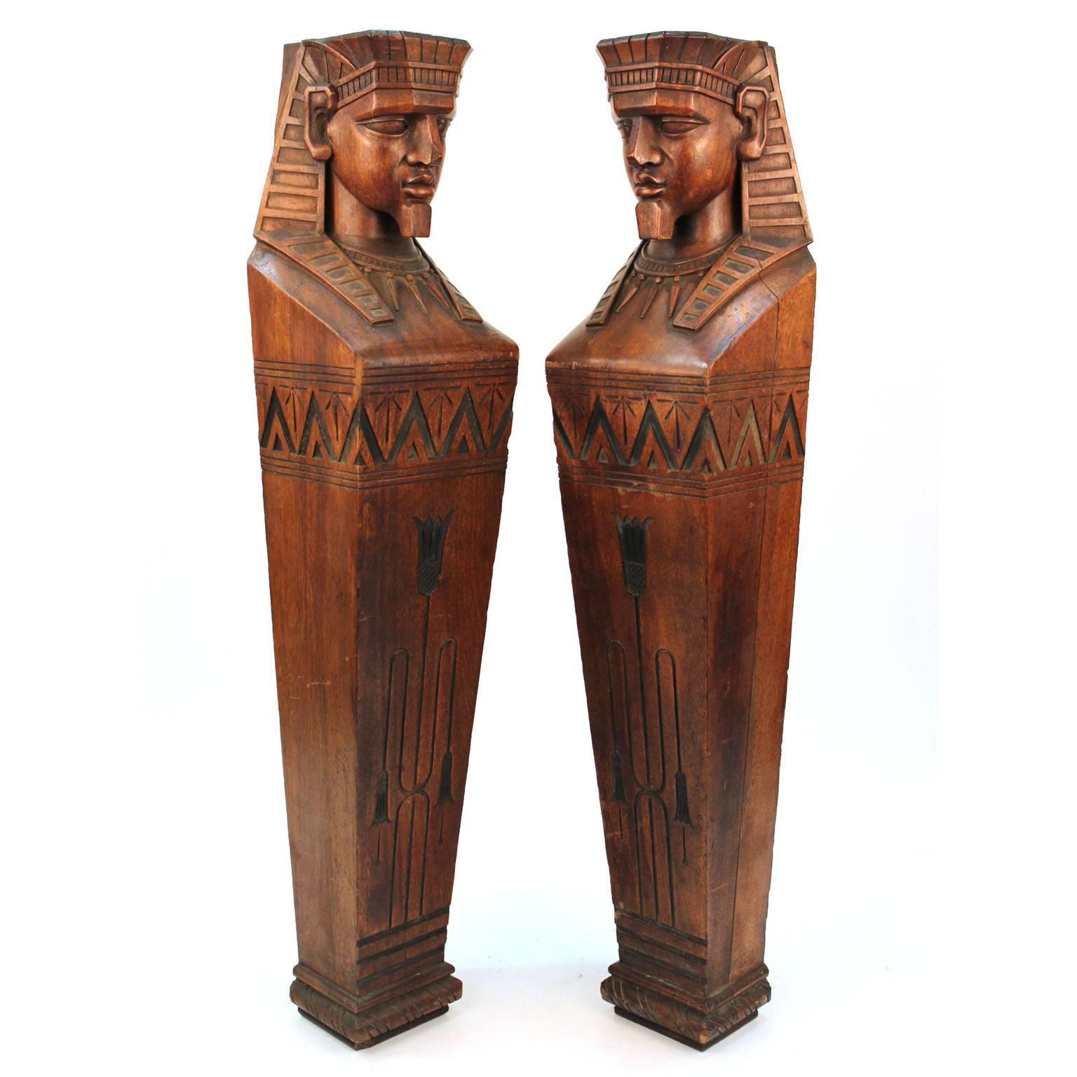 A pair of Egyptian Revival caryatids in carved wood with pharaonic attributes. Possibly originally part of a mantel or furniture piece. Good original condition; slight chip to one nose. Unmarked.