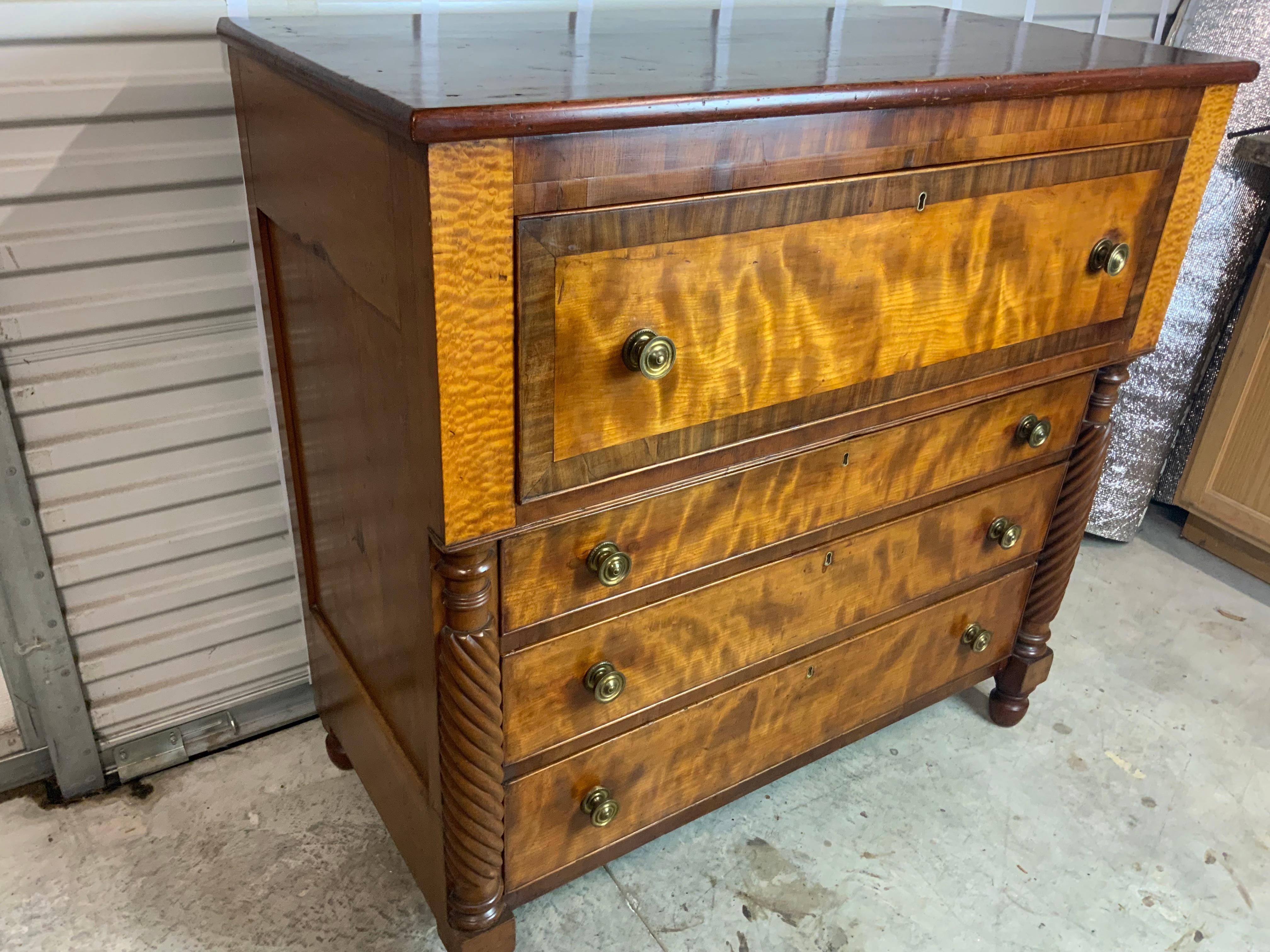  19th century figured Cherry and Quilted Maple Butlers Desk.  Nicely figured Cherry on the case and drawer fronts and quilted Maple on the top of the carved twisted columns and the fitted interior drawers.  New fabric has been installed on the