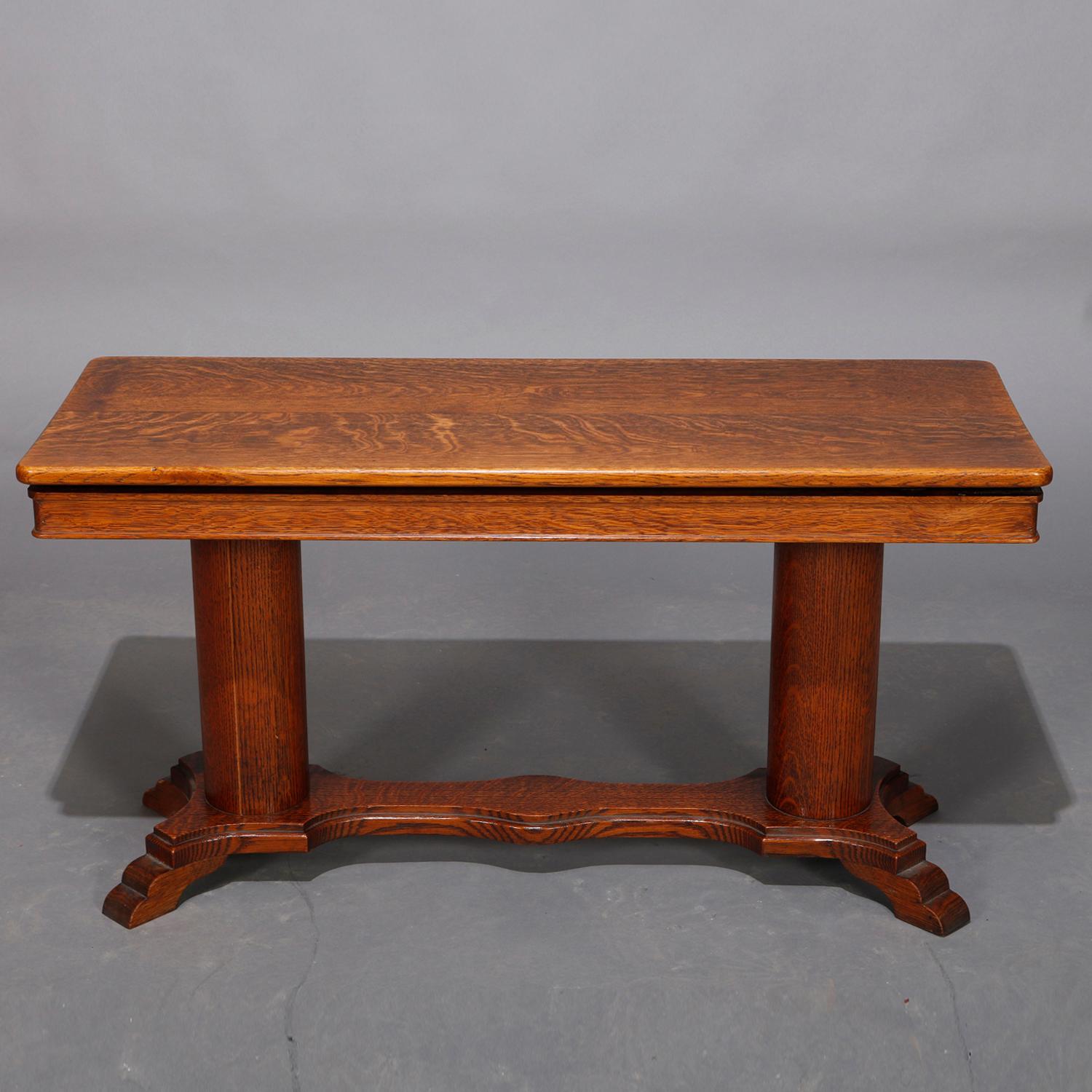 An antique American Empire piano bench offers lift top seat surmounting double pedestal base having shaped stretcher and stepped feet, 20th century

Measures: 21
