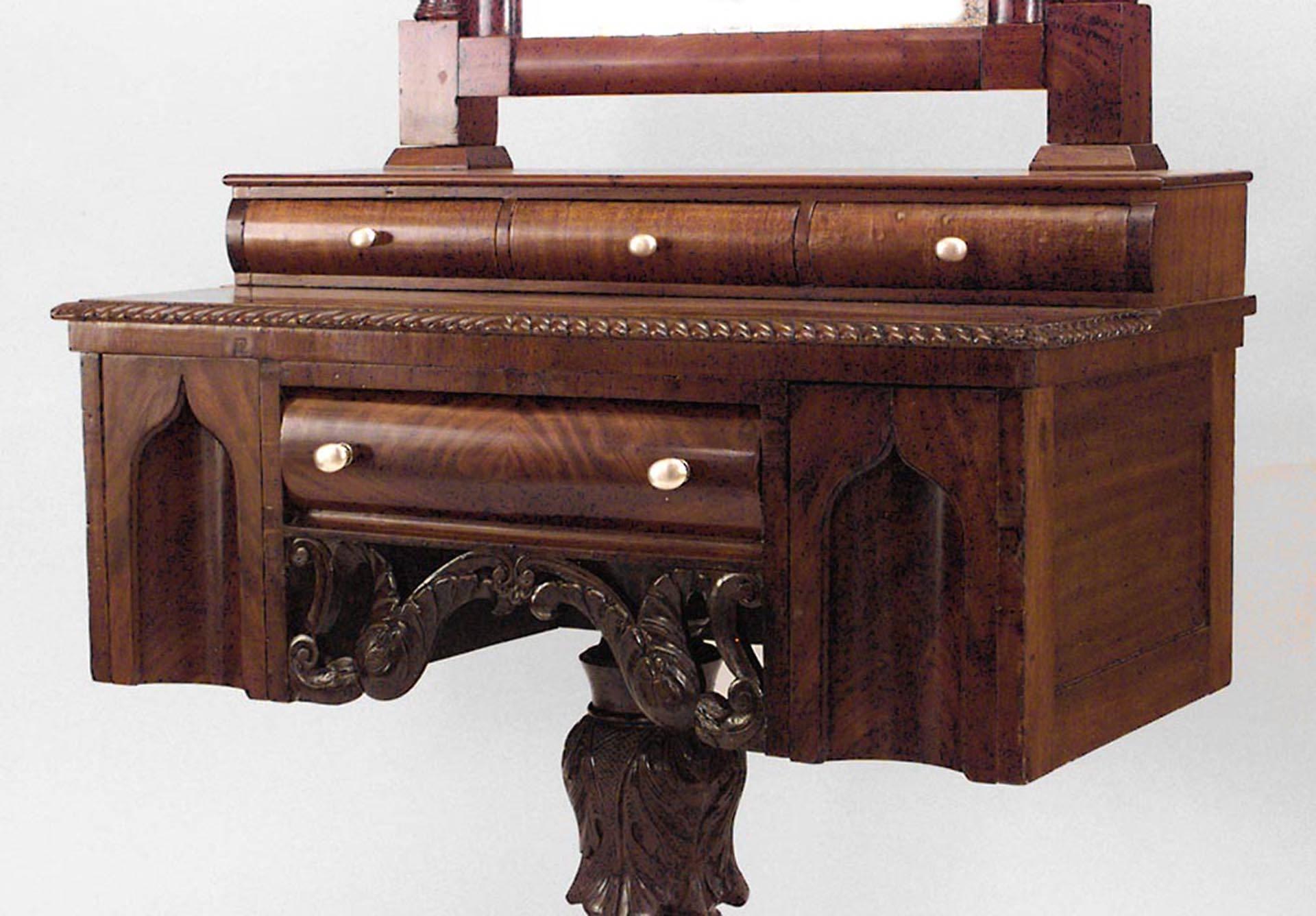 American Empire Gothic design mahogany dressing table on carved pedestal base with mirror and drawers.
