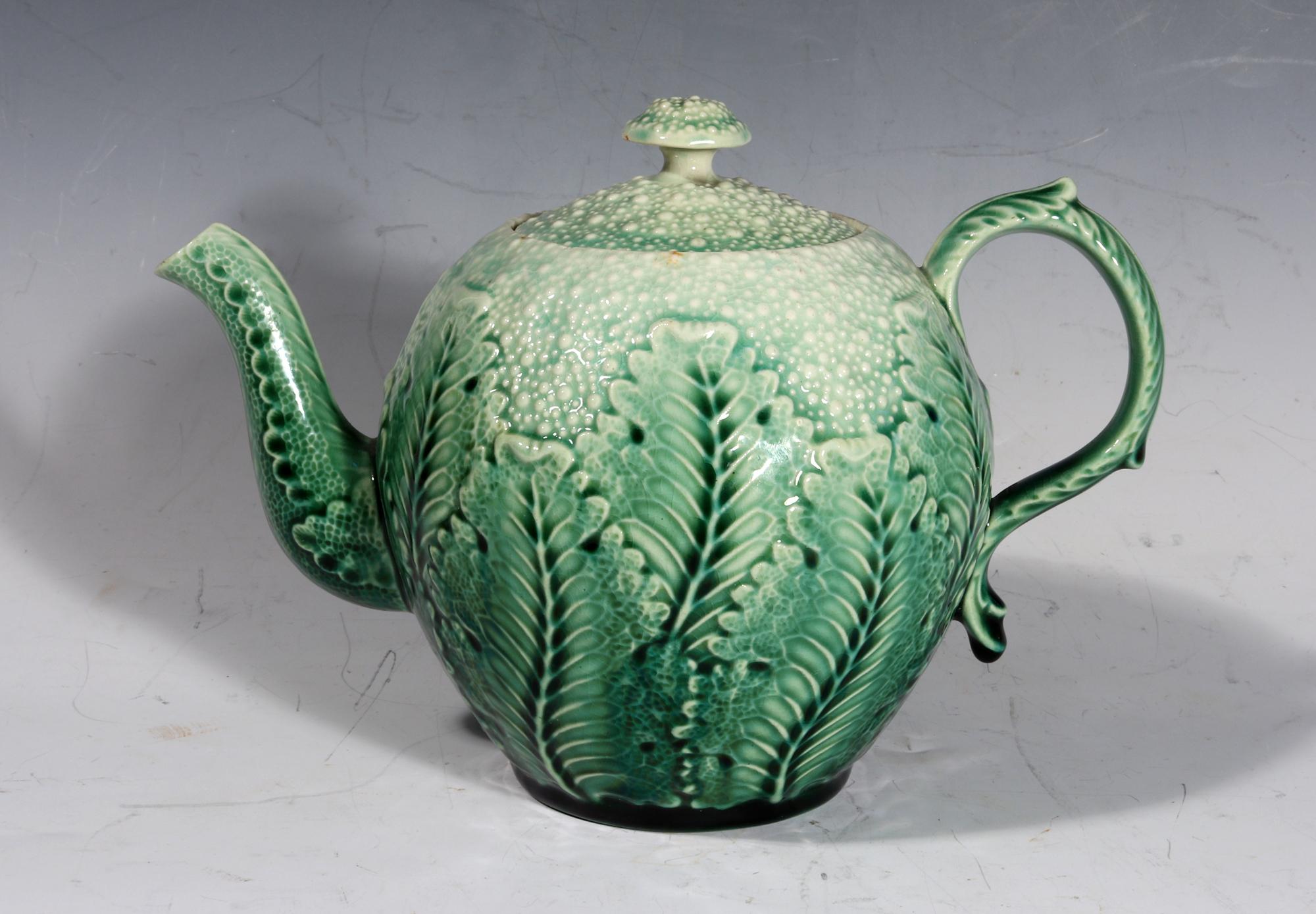 American Etruscan Majolica Teapot in the form of a Cauliflower,
Early Majolica-type body,
Circa 1860

The green molded tromp L'oeil teapot is designed as a small cauliflower, the sides with overlapping leaves.

Dimensions: 5 3/4 inches high x