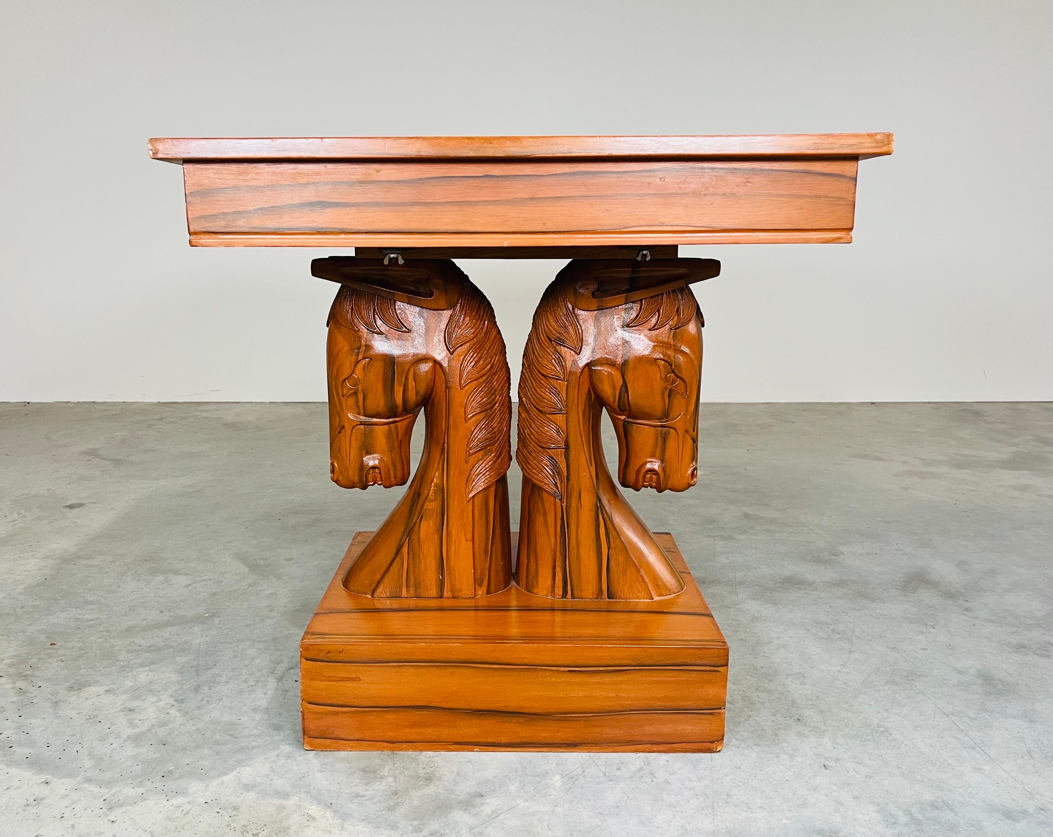 A unique and fanciful knight chess table in blended woods, the top is supported by a mahogany pedestal carved in the form of a pair of opposing horse's heads that rests on a square base, after William (Billy) Haines.
American, circa 1960
28x27x27”