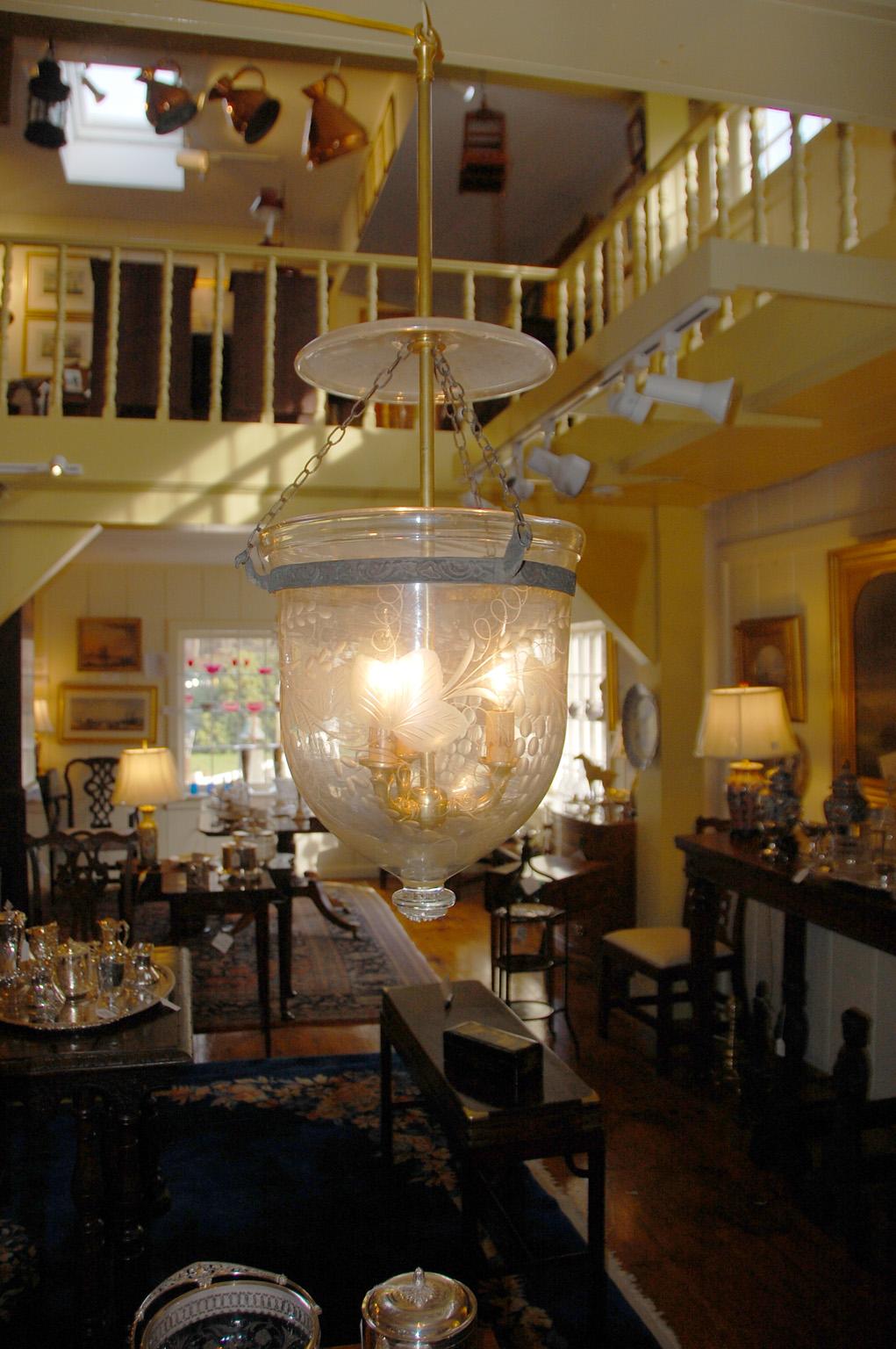 American Federal blown glass hanging light, with blown hollow rim and original blown glass smoke dome. The glass is etched and cut with clusters of grapes and grape vines. The central brass rod ending in three cast brass candleholders is a