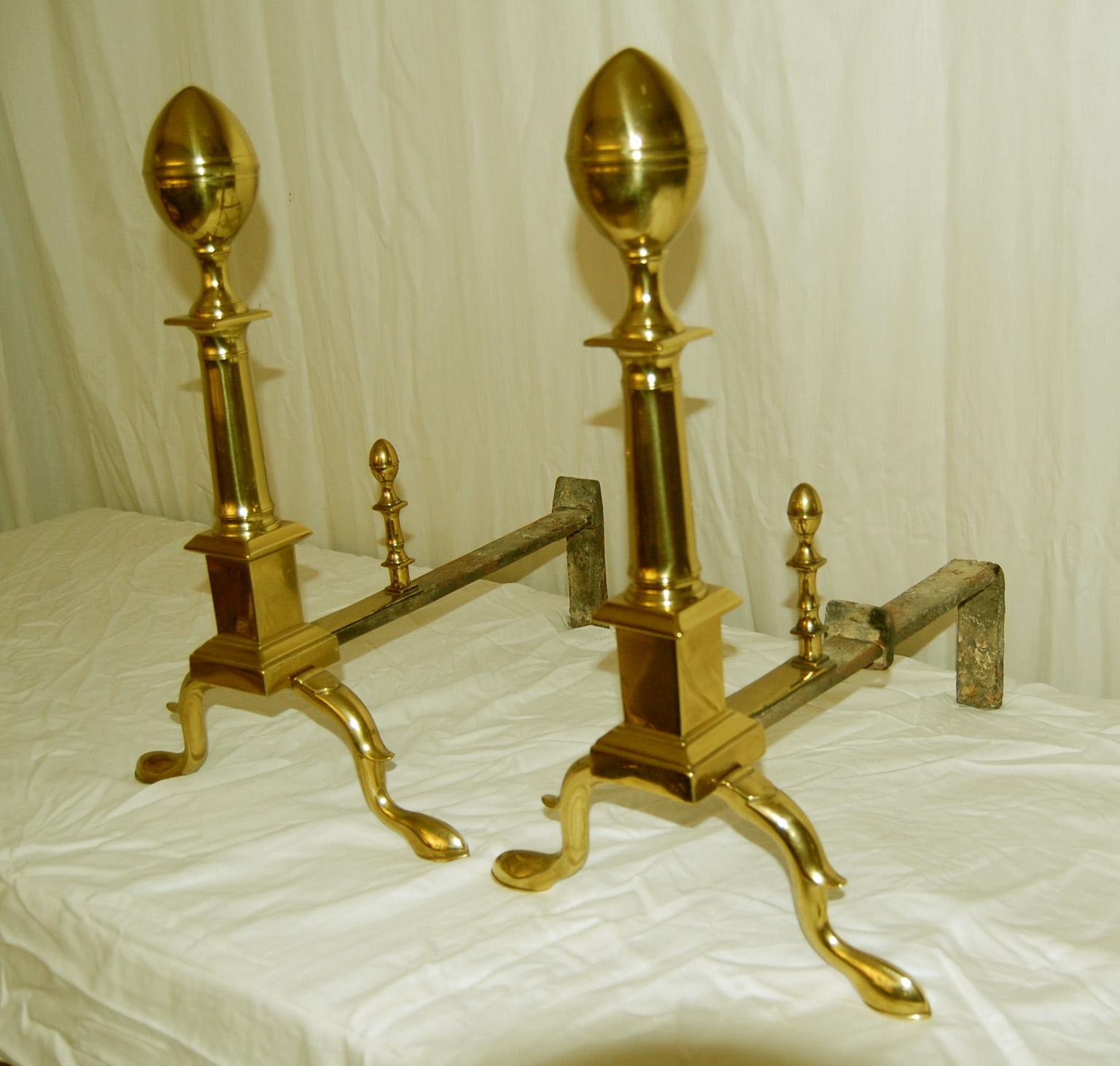  American Federal cast brass seamed 20 inch high lemon top andirons with slipper feet and iron log holders.  This pair of quite substantial andirons retain their original lemon top log stops.   Their elegant simplicity is a hall mark of fine federal
