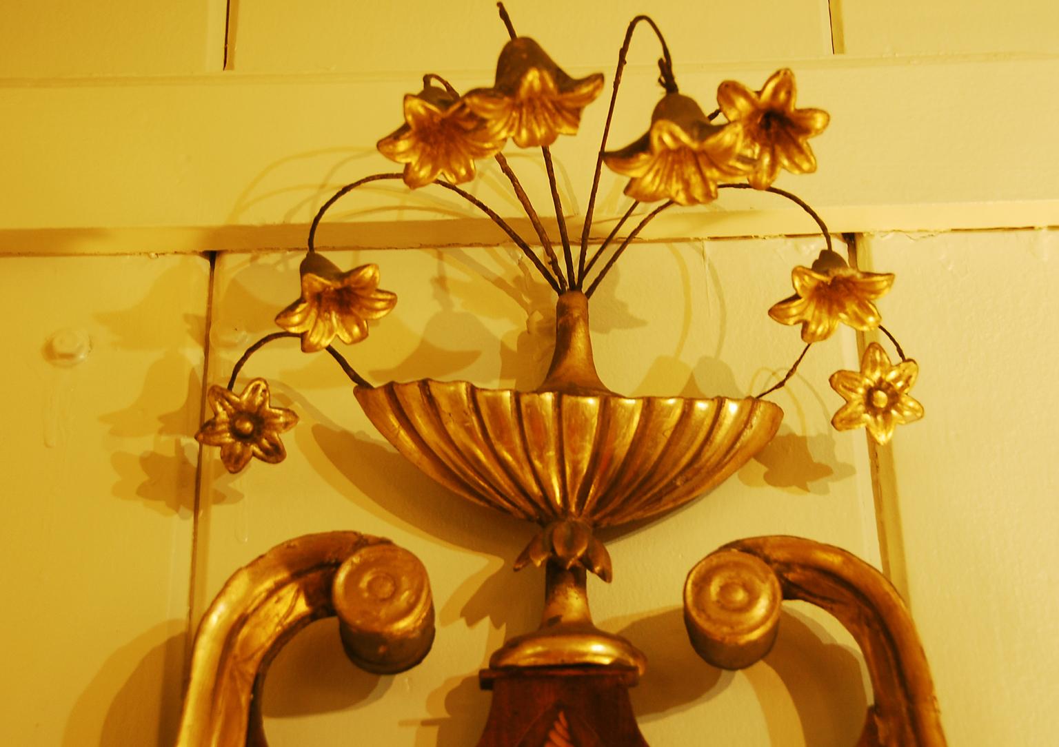 American Federal period Chippendale mahogany looking glass with broken arch pediment, boxwood inlaid shell motif and stringing.  The broken arch is highlighted in gold leaf.  The carved gold leafed urn has delicate gold leafed flowers on wire stems 