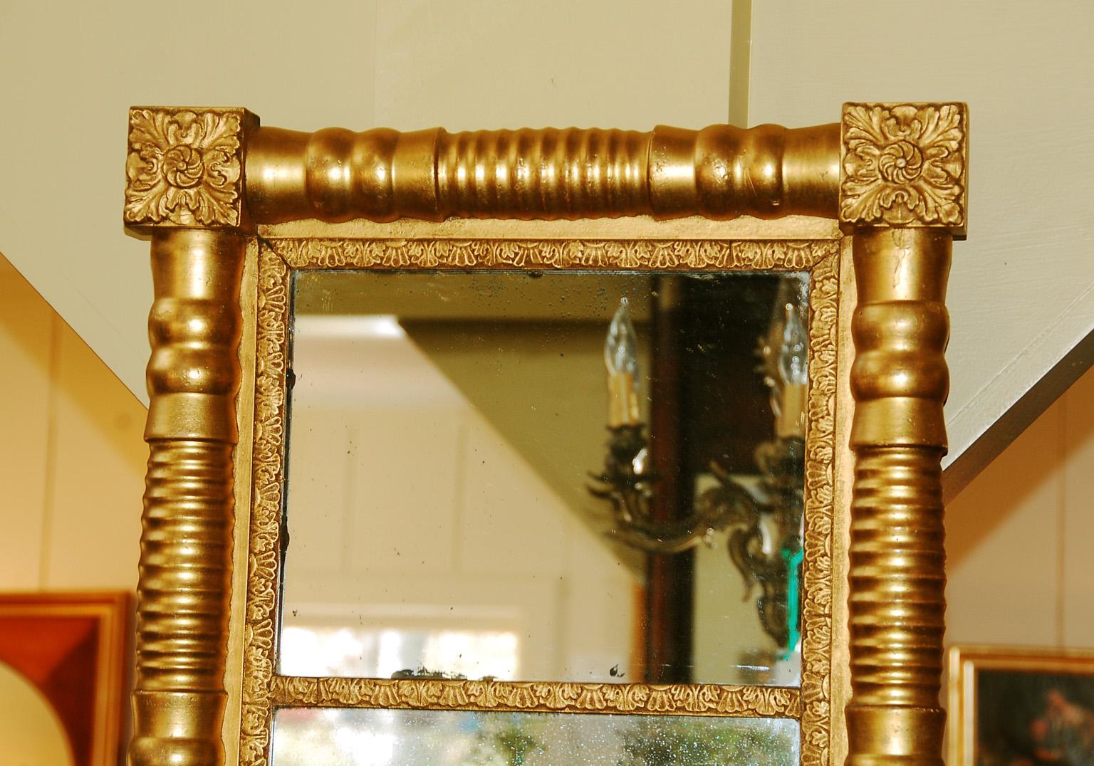 American Federal gold leaf mirror with hand turned ribbed half column pilasters, fancy inner border, and square corners with acanthus leaves. This two part vertical mirror has original mirror in both sections and the gold leaf is in excellent