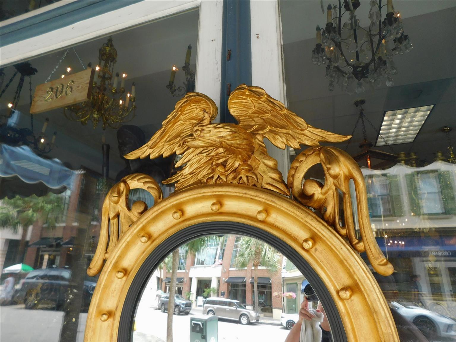 Early 19th Century American Federal Gilt Wood Convex Mirror with Perched Eagle to Flee, Circa 1820 For Sale