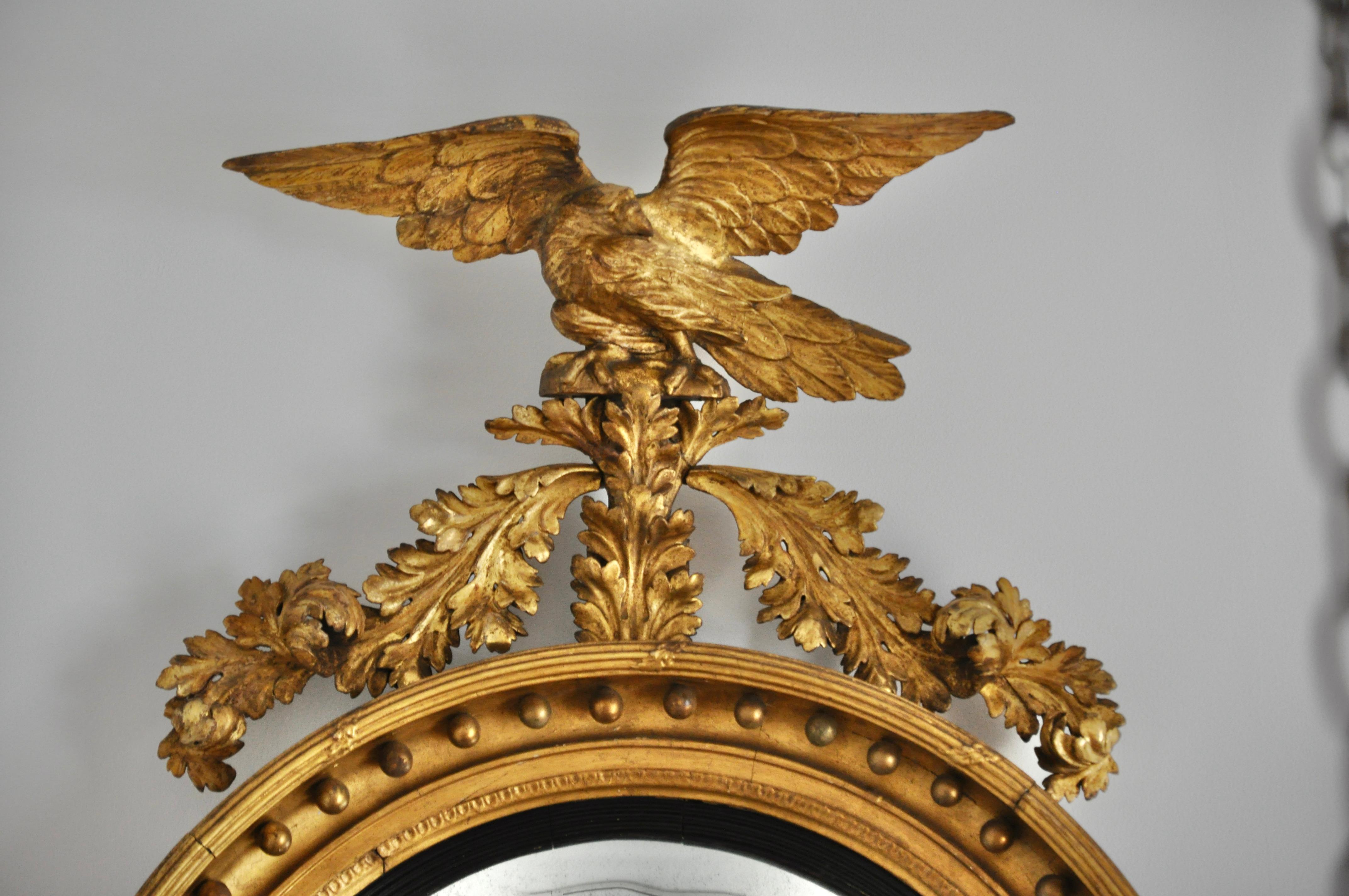 Large scale convex mirror with eagle. Of grand nature in original as found gilding. Though is very difficult to determine in these mirrors are English or American, this particular mirror most definitely has American Federal sensibility.

Note: The