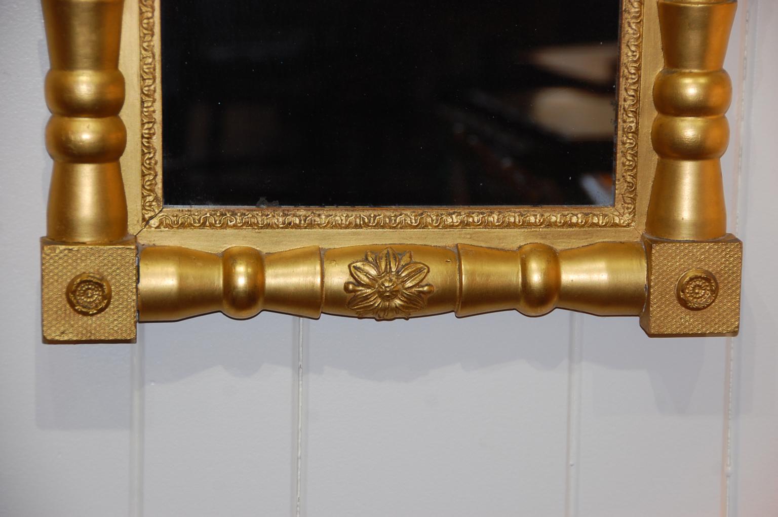 American Federal period gold leaf split column mirror with period corner and column fleurettes embellishments, Circa 1800.