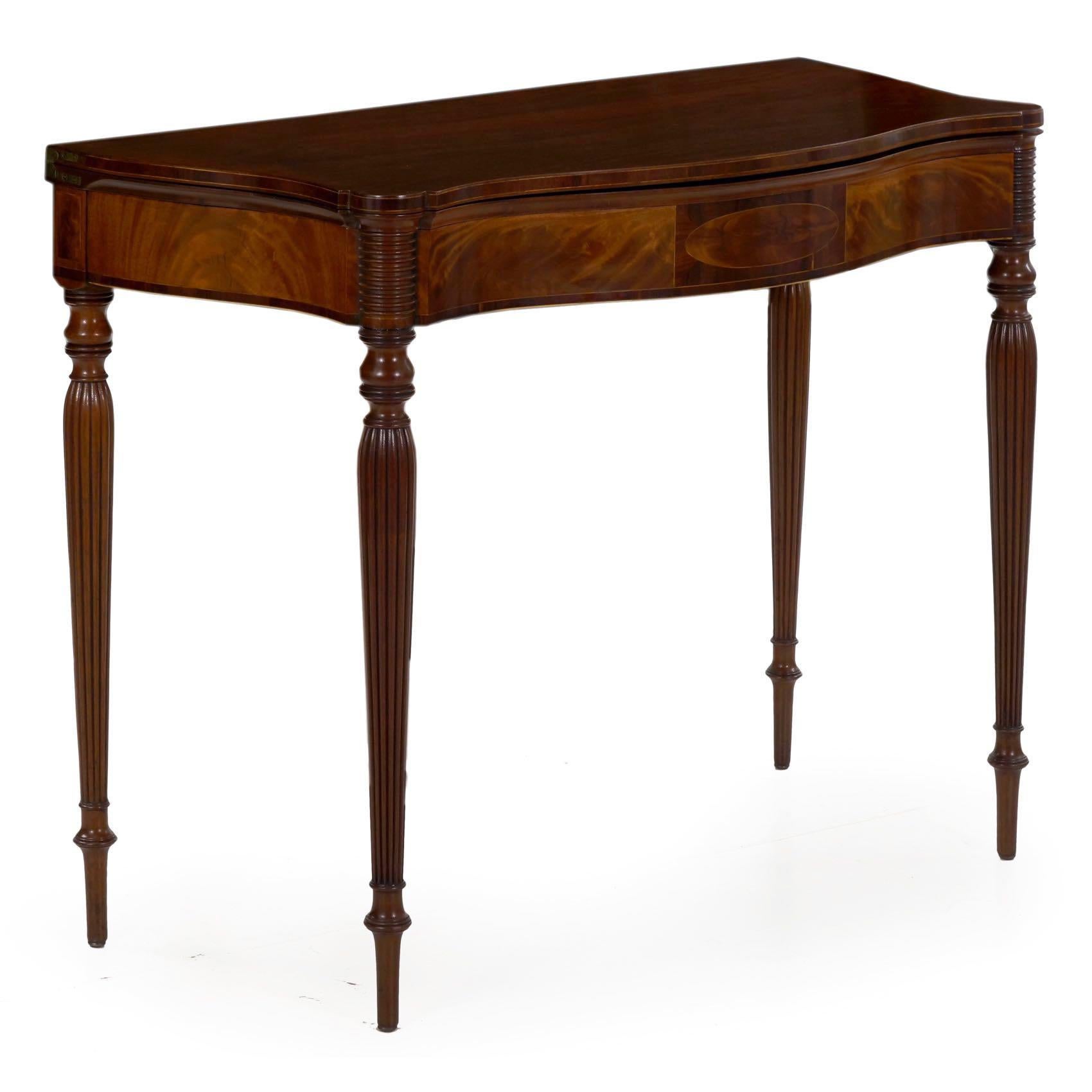 A very fine Sheraton card table from the first quarter of the 19th century, it features a fine serpentine form that is most exaggerated, the front with a cupid's bow curvature that follows through in the undulating sides. This is only seen when the